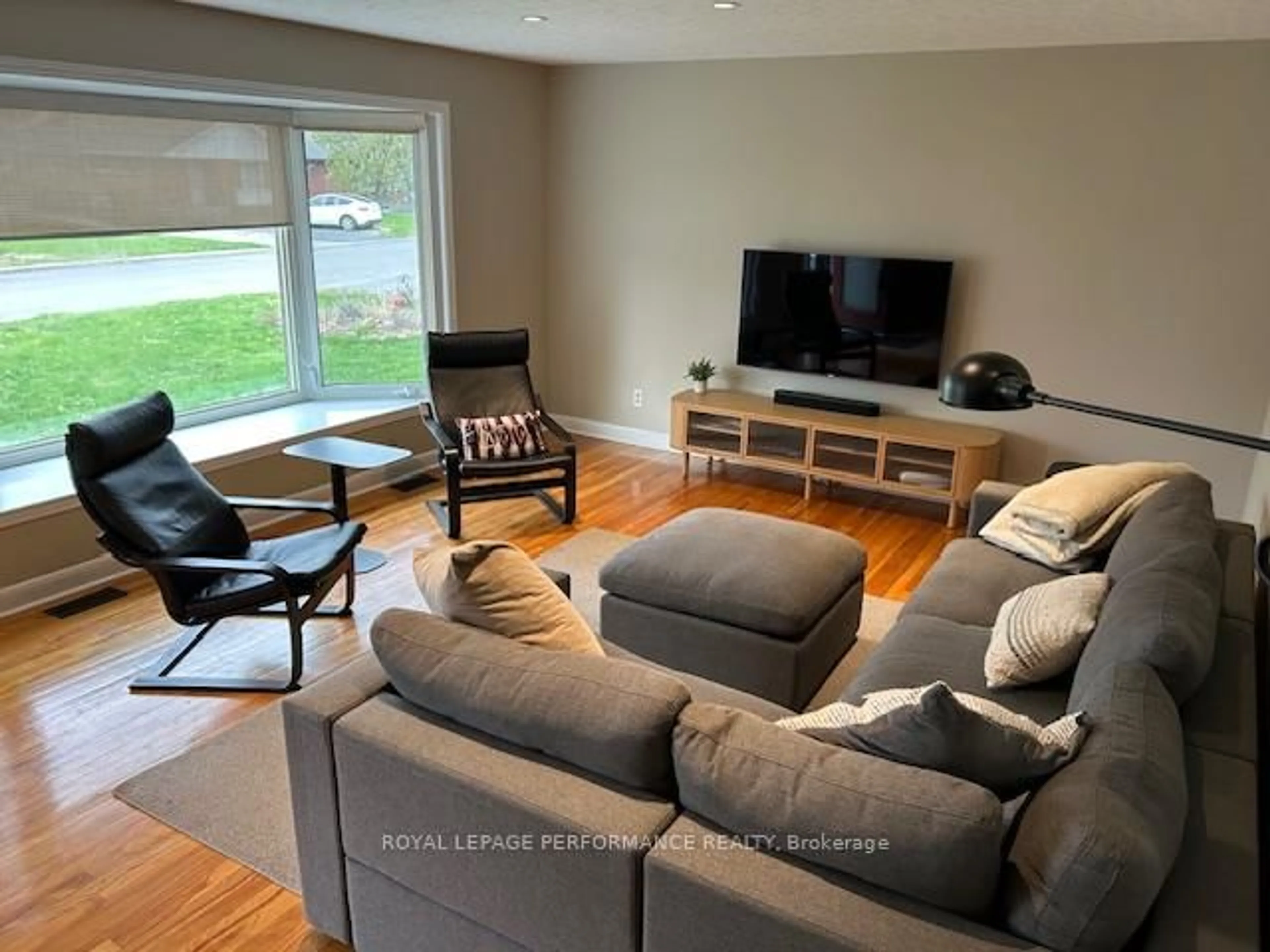 Living room with furniture, wood/laminate floor for 1321 Rustic Dr, Ottawa Ontario K2C 2Y3