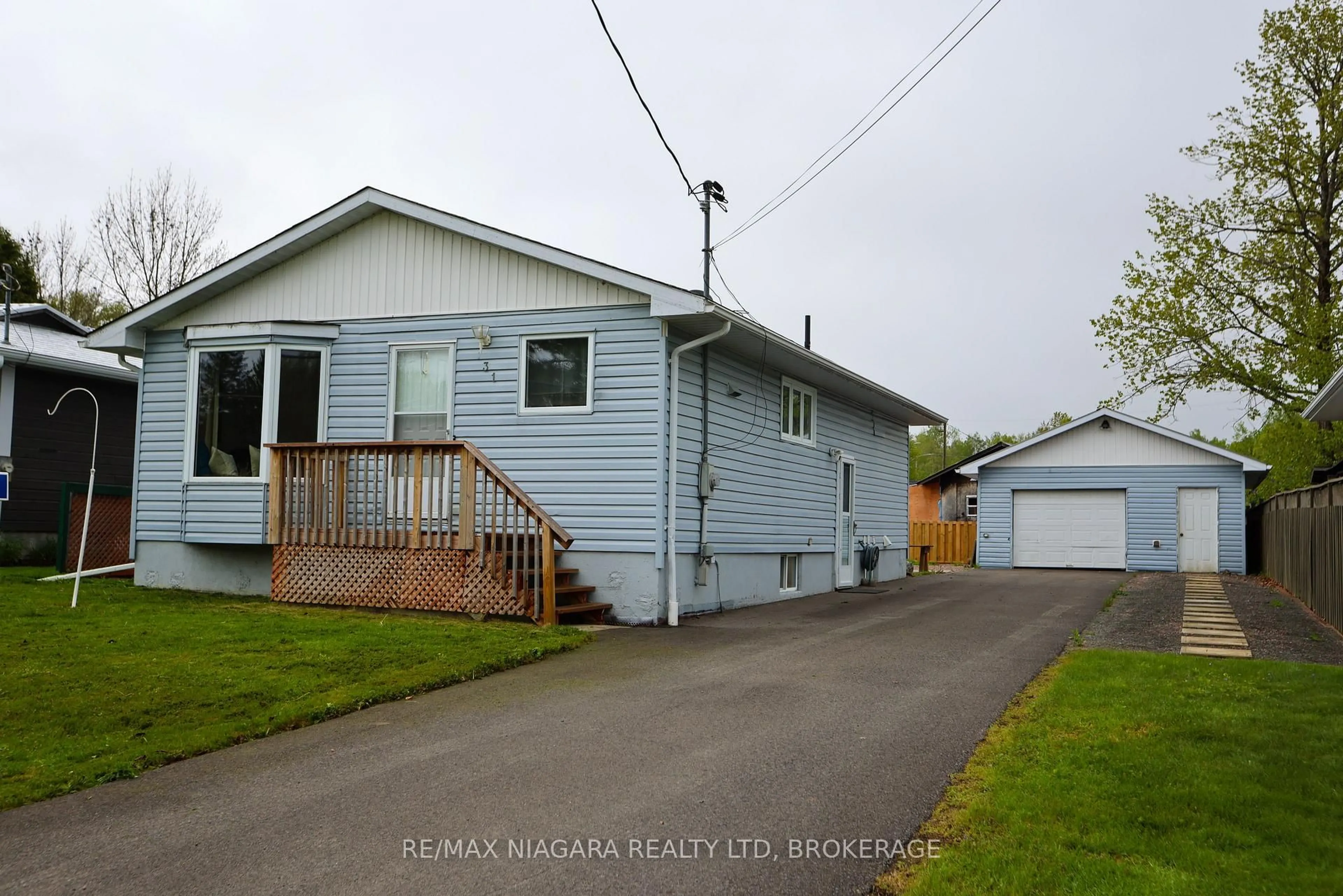 Home with vinyl exterior material, street for 31 Spruce Dr, Temagami Ontario P0H 2H0