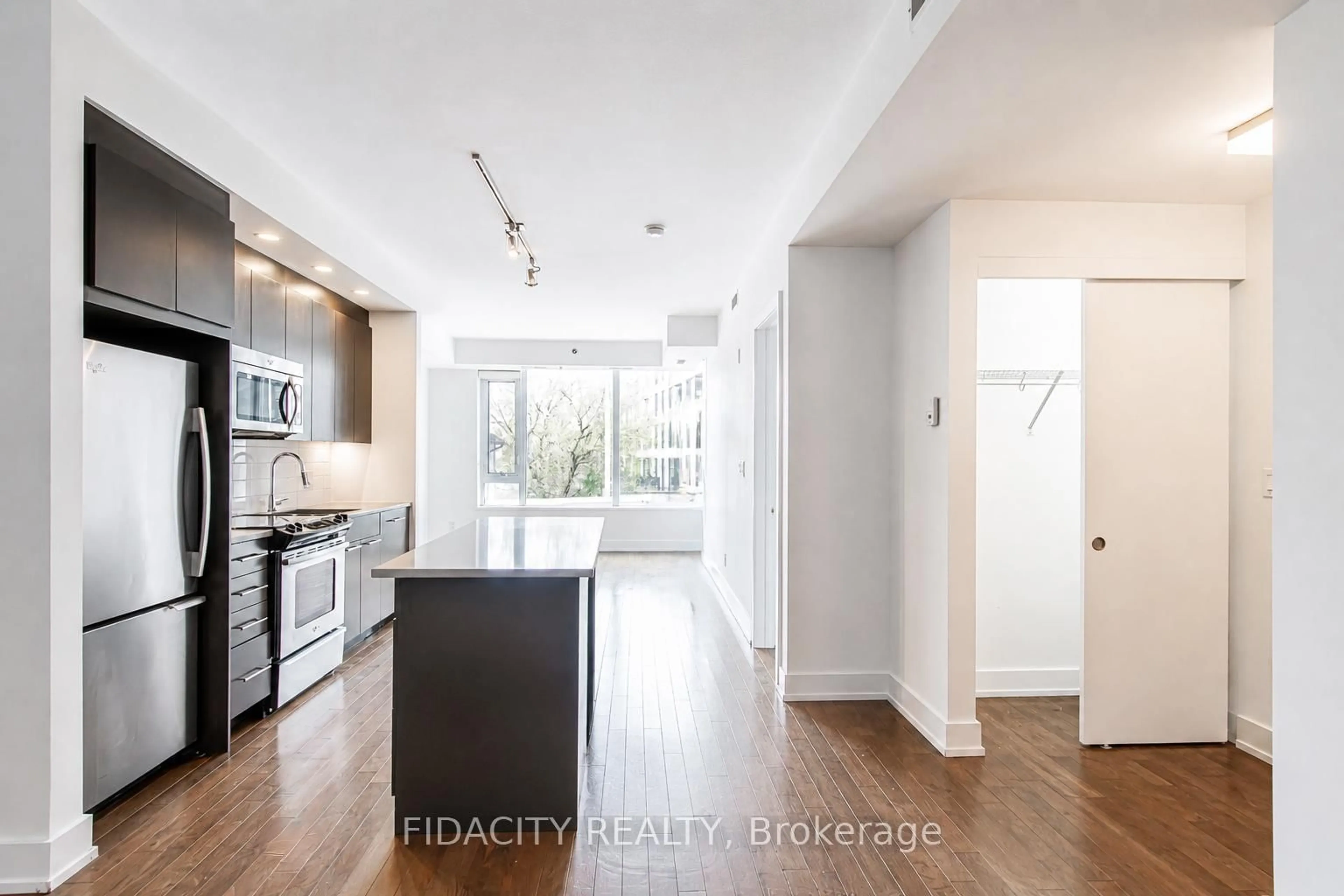 Open concept kitchen, wood/laminate floor for 360 Patricia Ave #201, Ottawa Ontario K1Z 0A8