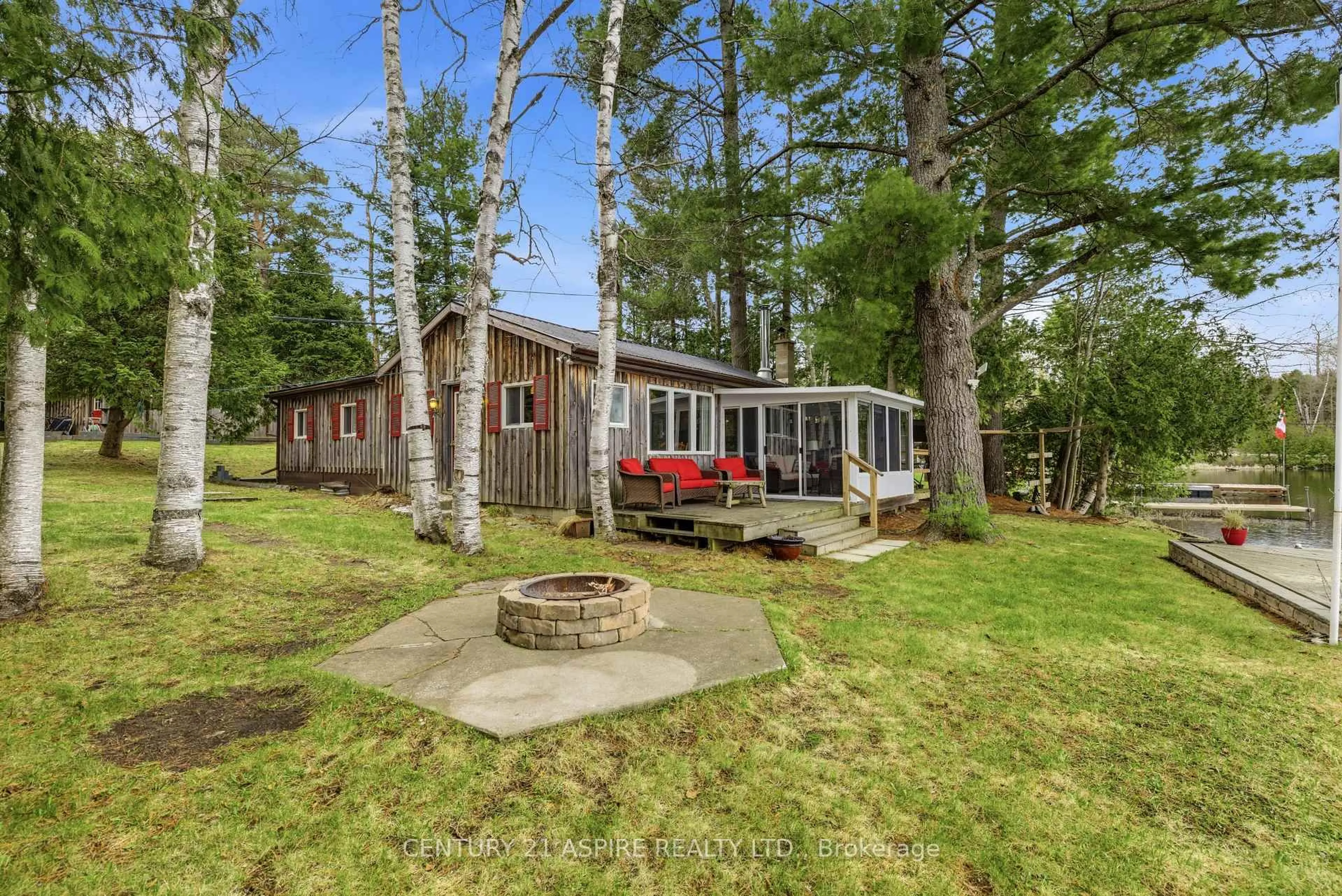 A pic from outside/outdoor area/front of a property/back of a property/a pic from drone, water/lake/river/ocean view for 1023 Perry Point Lane, Arden Ontario K0H 1B0