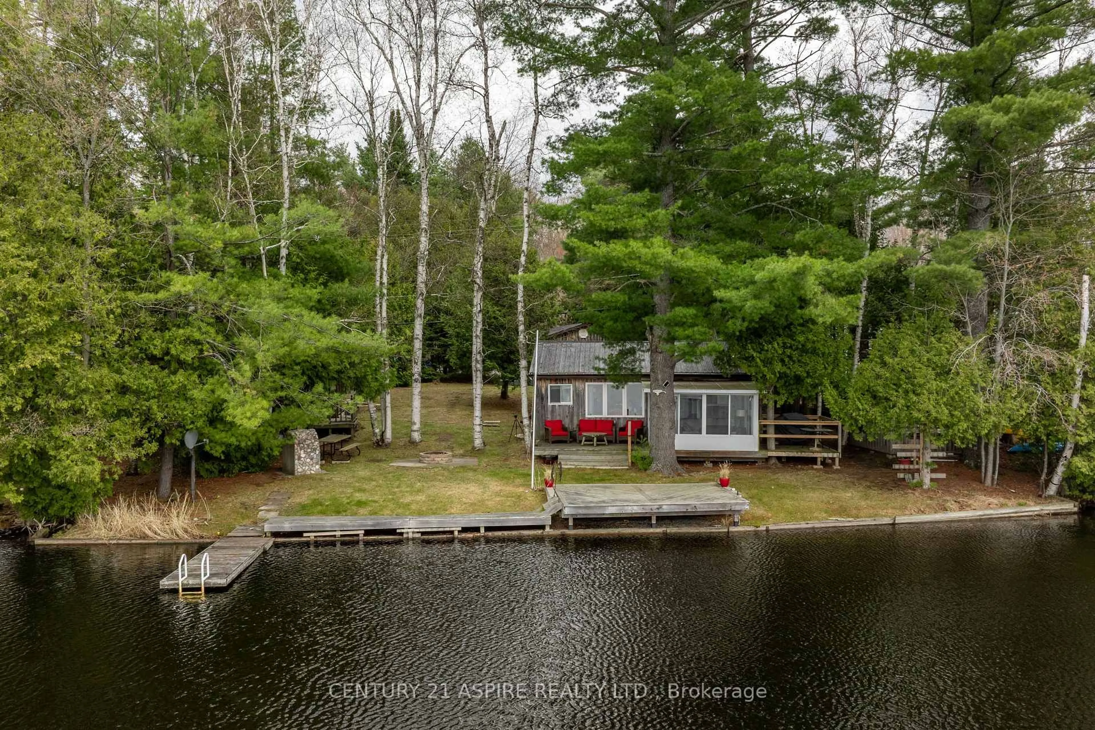 A pic from outside/outdoor area/front of a property/back of a property/a pic from drone, water/lake/river/ocean view for 1023 Perry Point Lane, Arden Ontario K0H 1B0