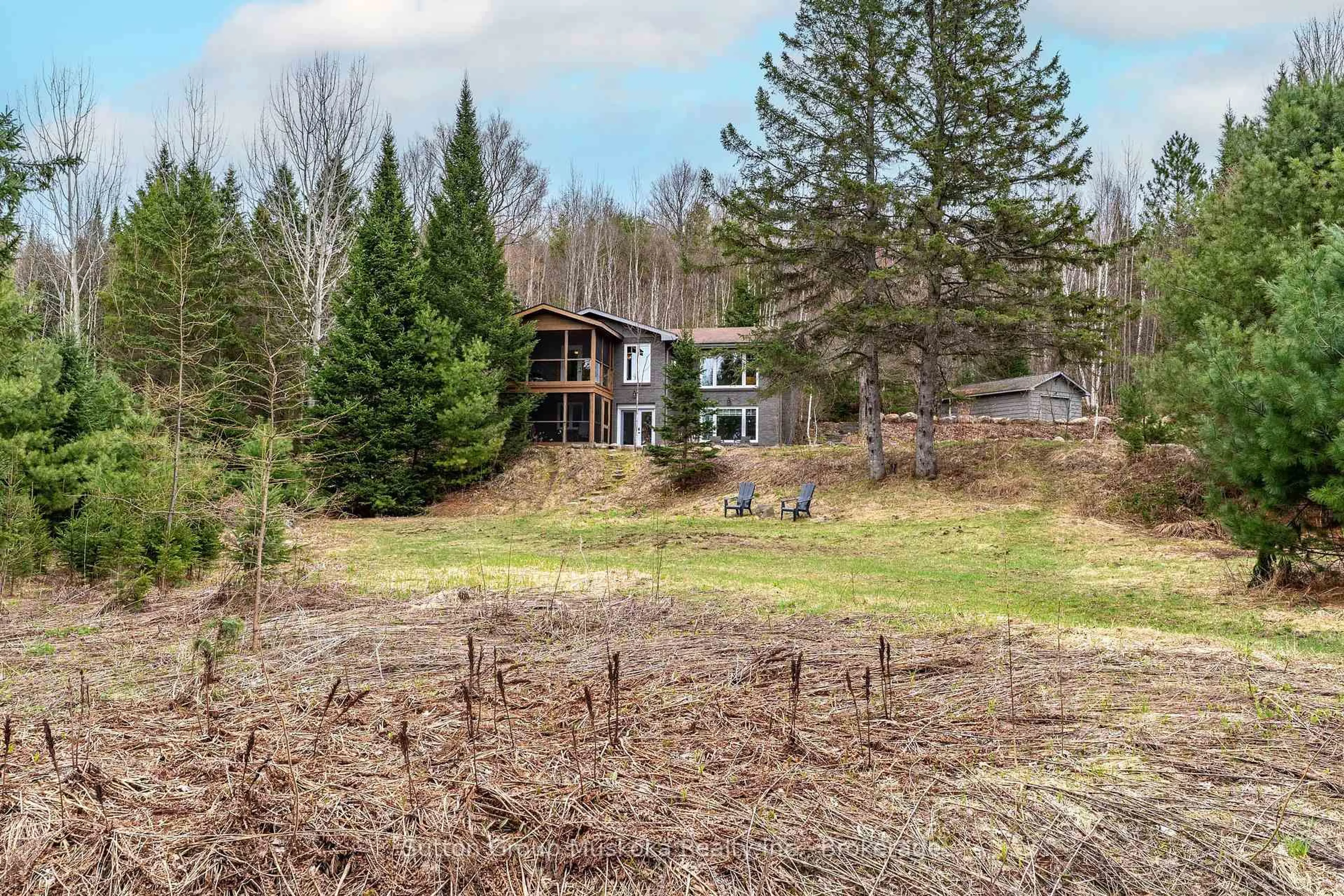 A pic from outside/outdoor area/front of a property/back of a property/a pic from drone, forest/trees view for 209 Swallowdale Rd, Huntsville Ontario P1H 0A5