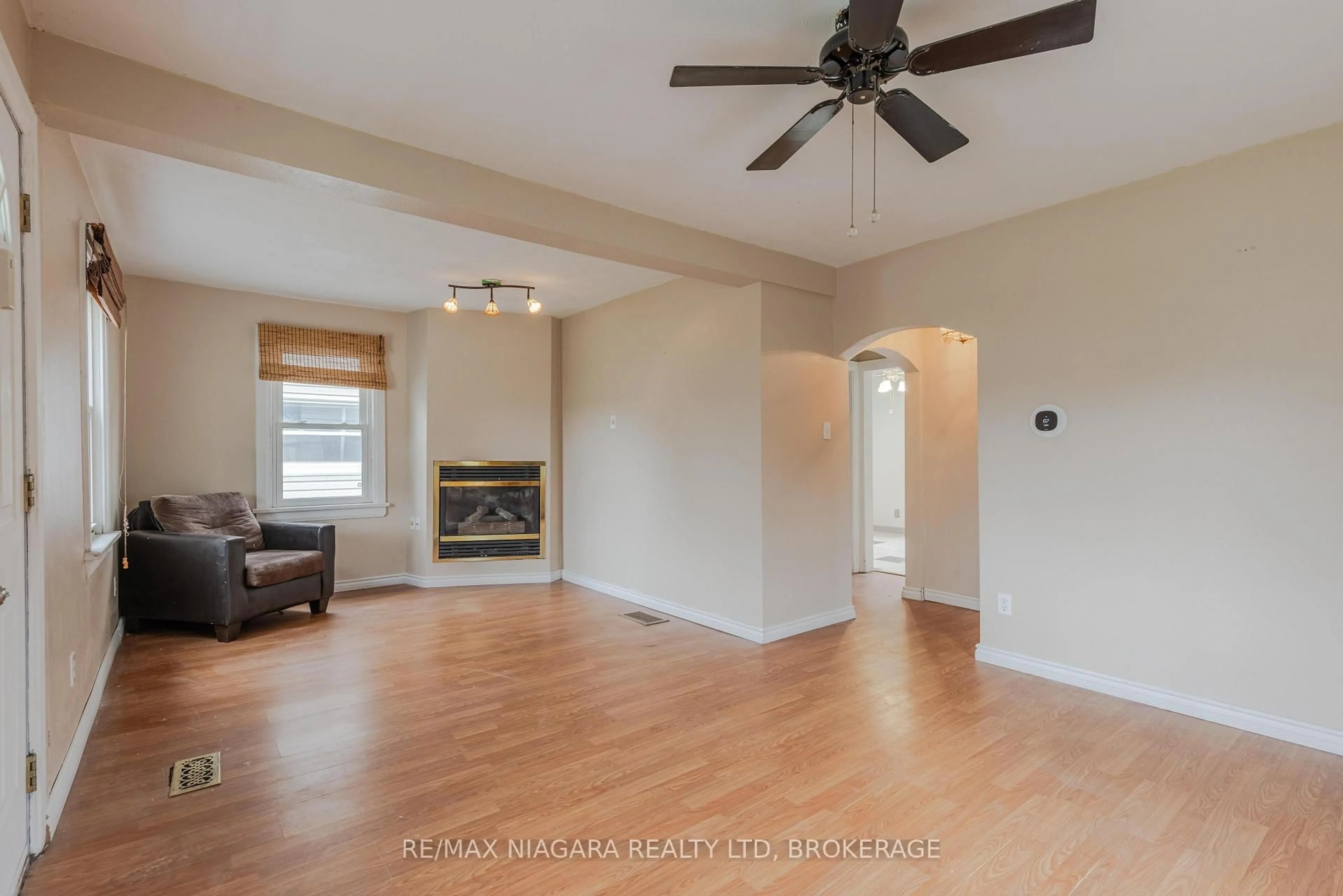 Living room with furniture, wood/laminate floor for 6407 Frederica St, Niagara Falls Ontario L2G 1C5