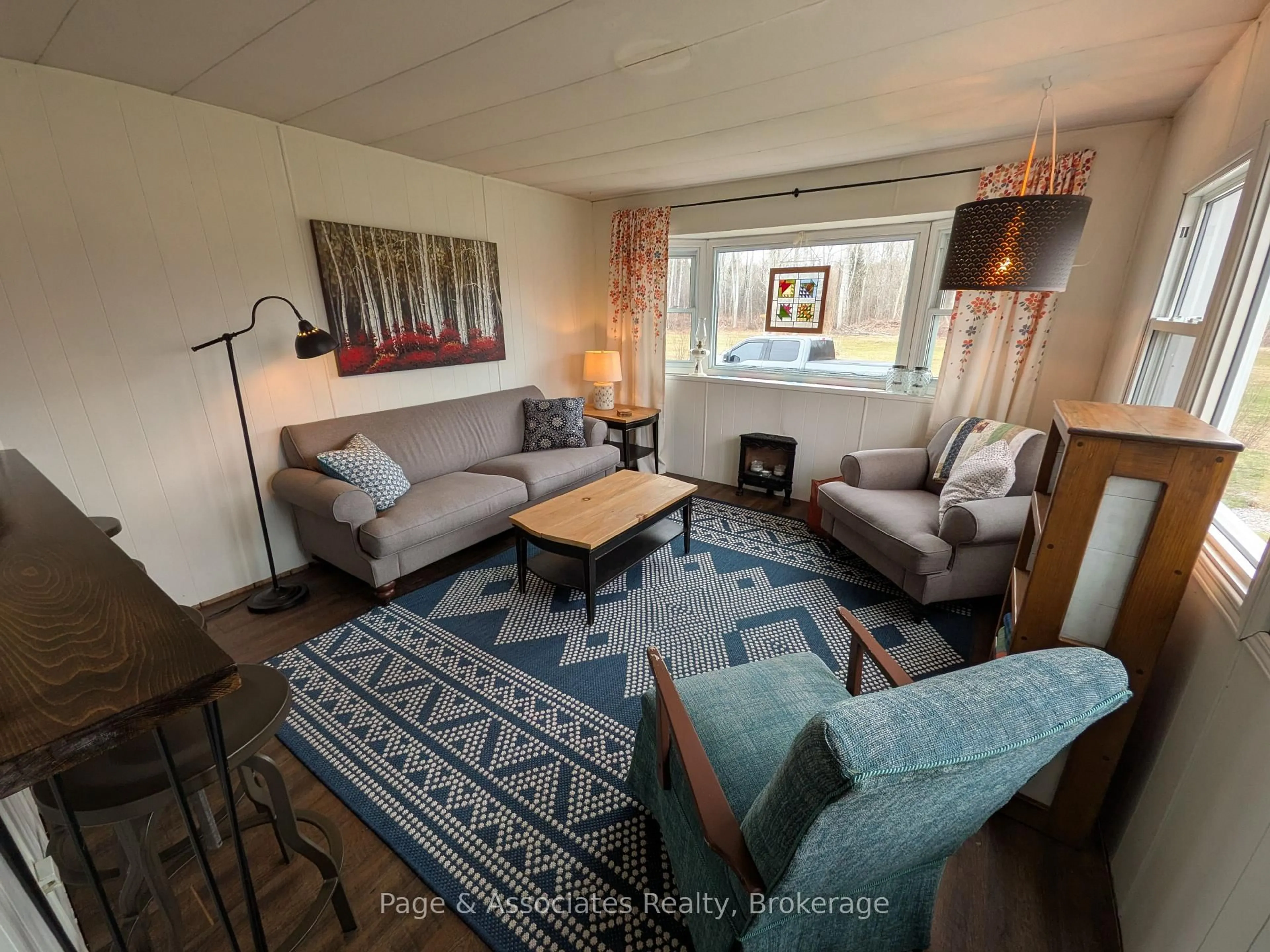 Living room with furniture, wood/laminate floor for 4456 Highway 535, St. Charles Ontario P0M 2W0