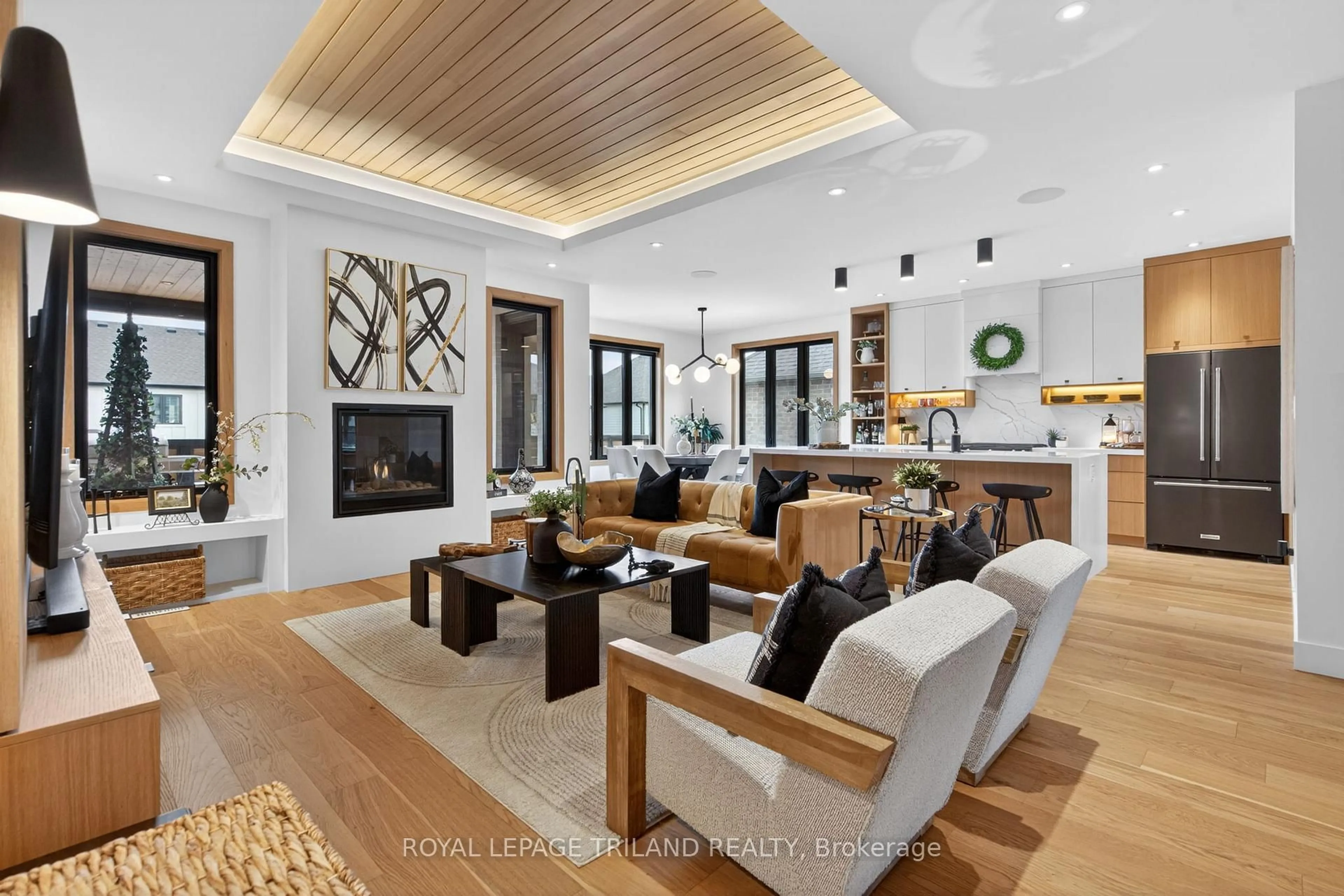 Living room with furniture, wood/laminate floor for 1055 Trailsway Ave, London South Ontario N6K 0J1