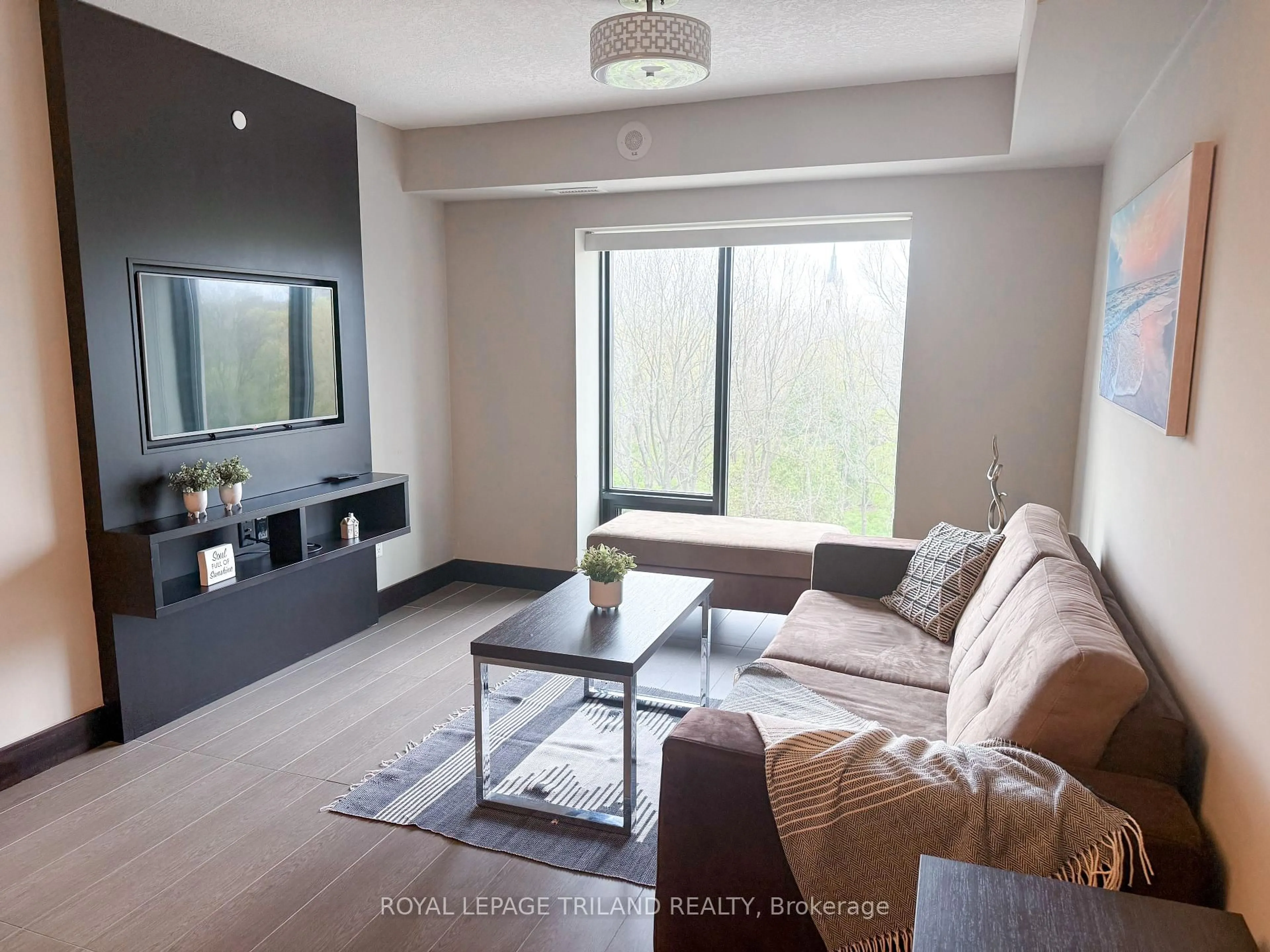 Living room with furniture, wood/laminate floor for 1235 Richmond St #607, London East Ontario N6A 0C1