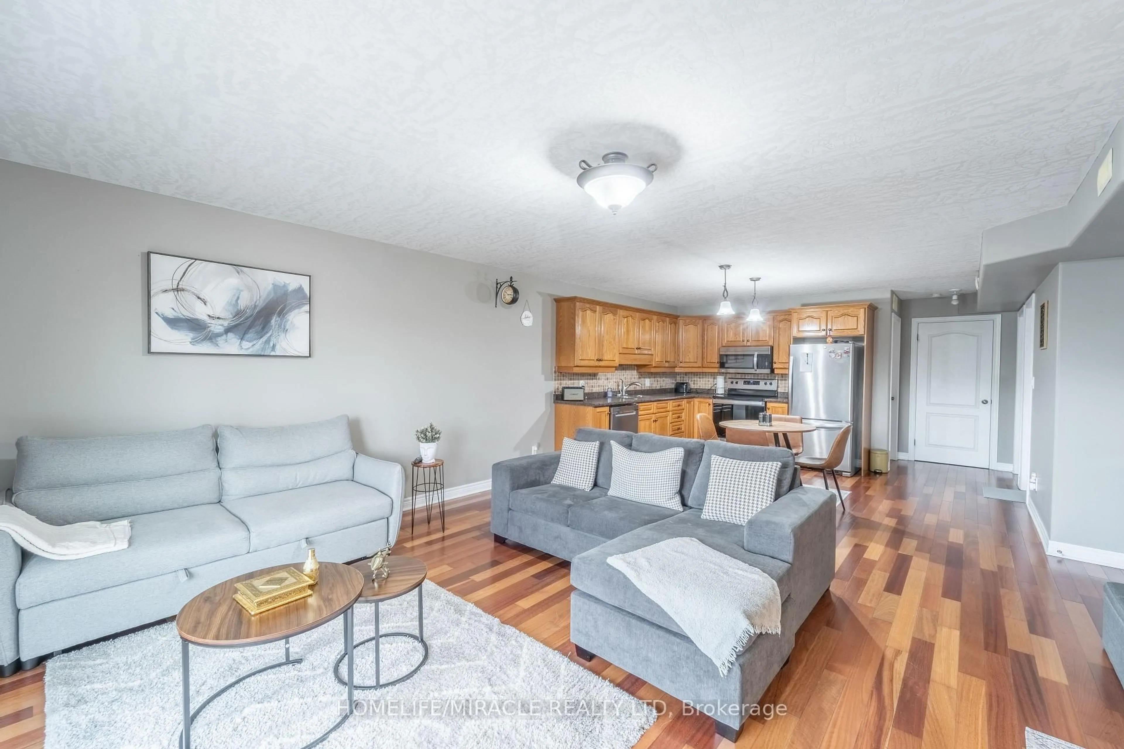 Living room with furniture, wood/laminate floor for 50 Whitlaw Way #203, Brant Ontario N3L 4C3