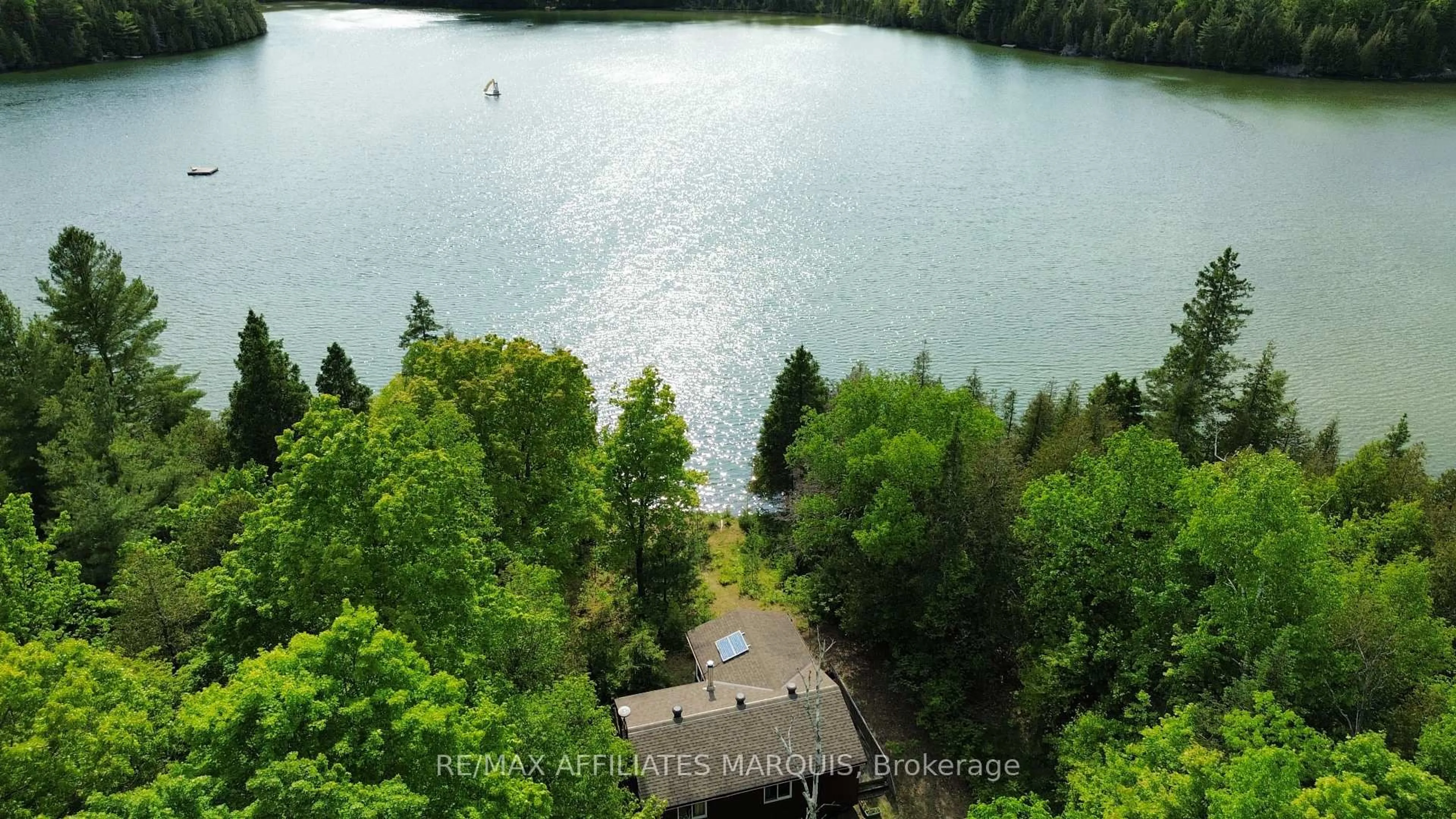A pic from outside/outdoor area/front of a property/back of a property/a pic from drone, water/lake/river/ocean view for 1015 Penyck  Lake Lane, Sharbot Lake Ontario K0H 2P0