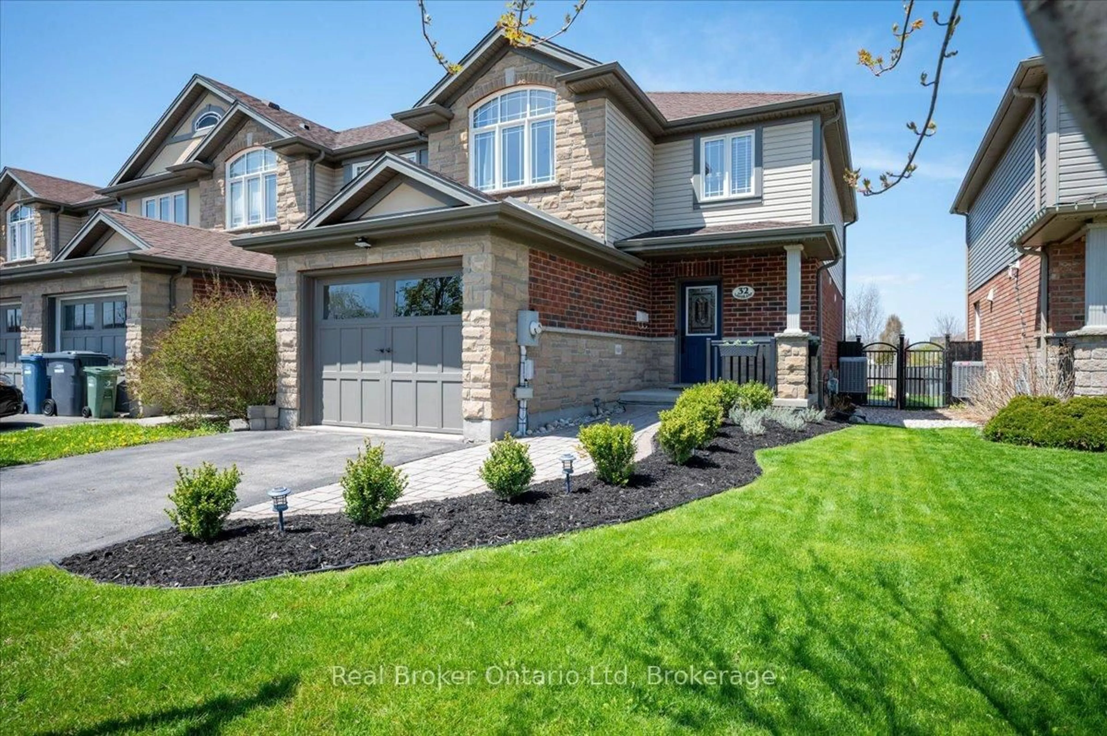 Home with brick exterior material, street for 32 Laughland Lane, Guelph Ontario N1L 0C9