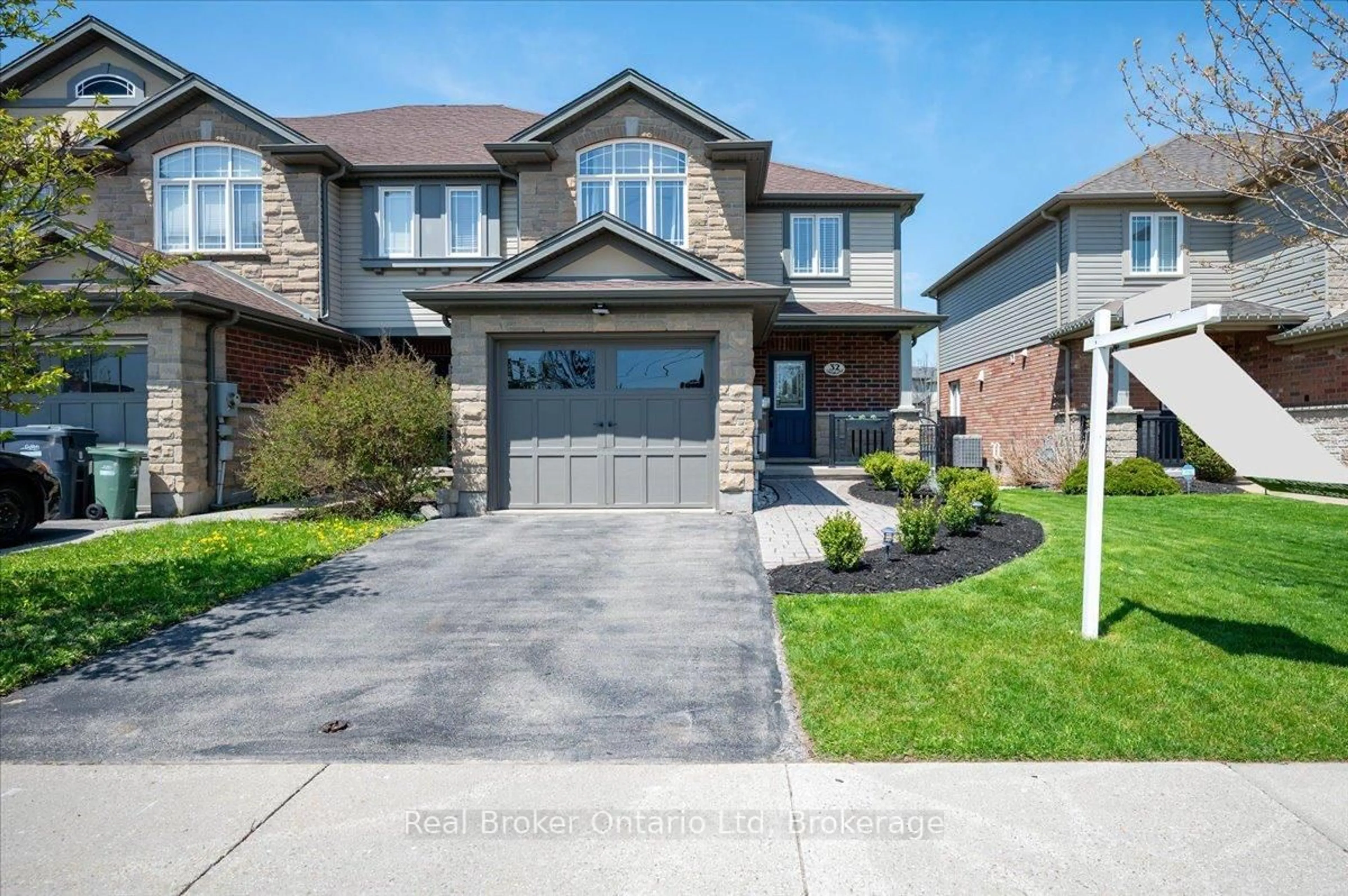 Home with brick exterior material, street for 32 Laughland Lane, Guelph Ontario N1L 0C9