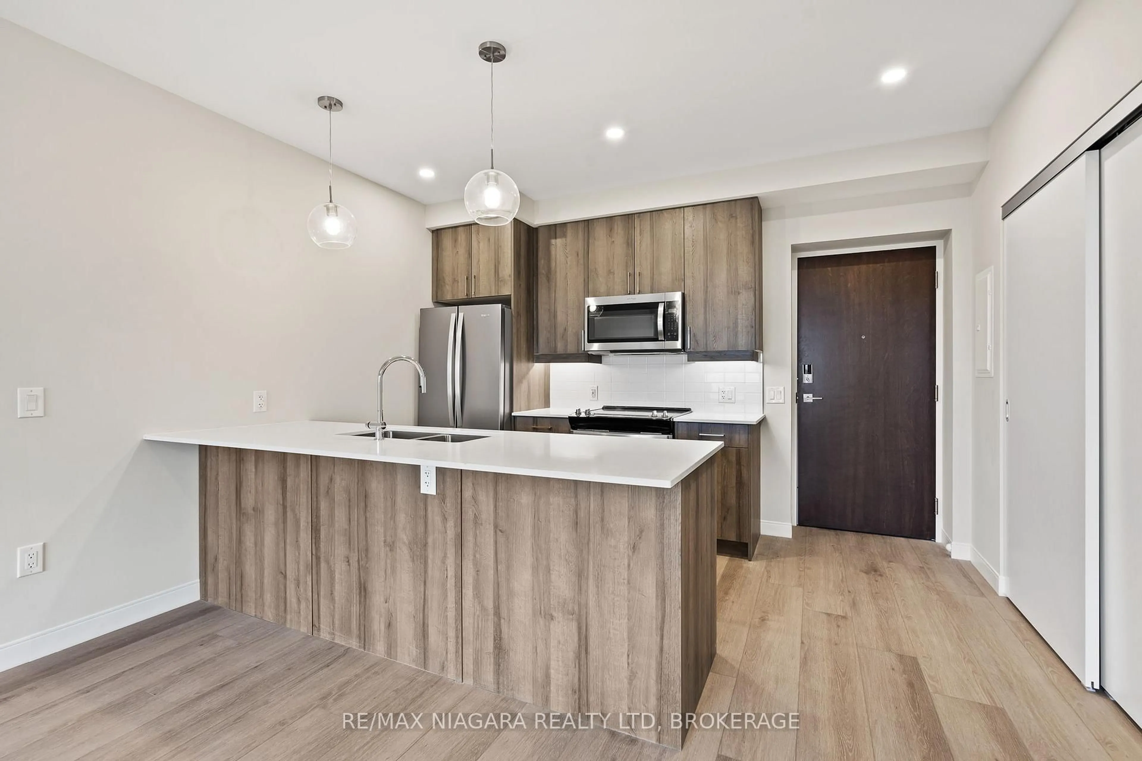 Open concept kitchen, wood/laminate floor for 118 West St #703, Port Colborne Ontario L3K 0B9