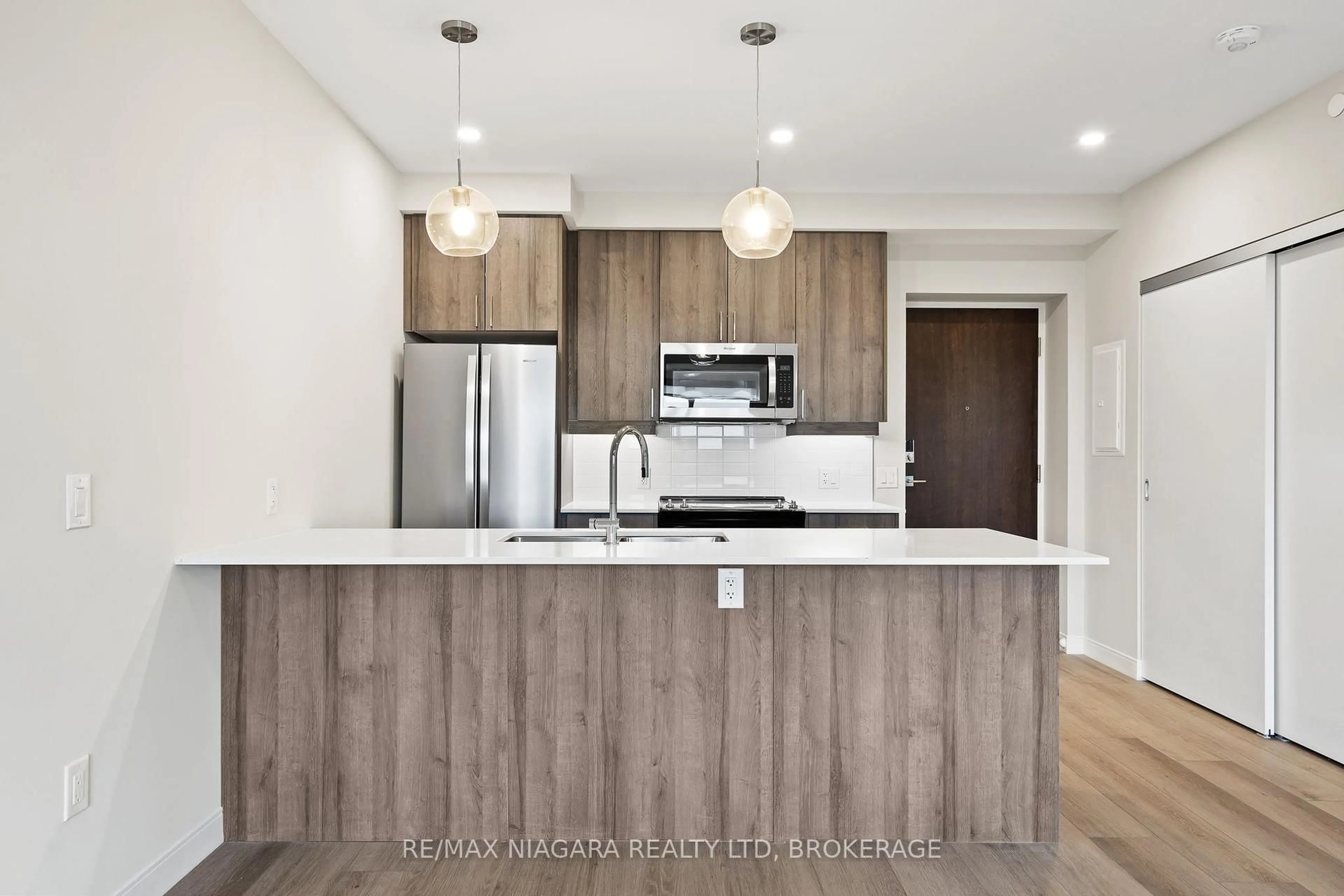 Open concept kitchen, wood/laminate floor for 118 West St #703, Port Colborne Ontario L3K 0B9
