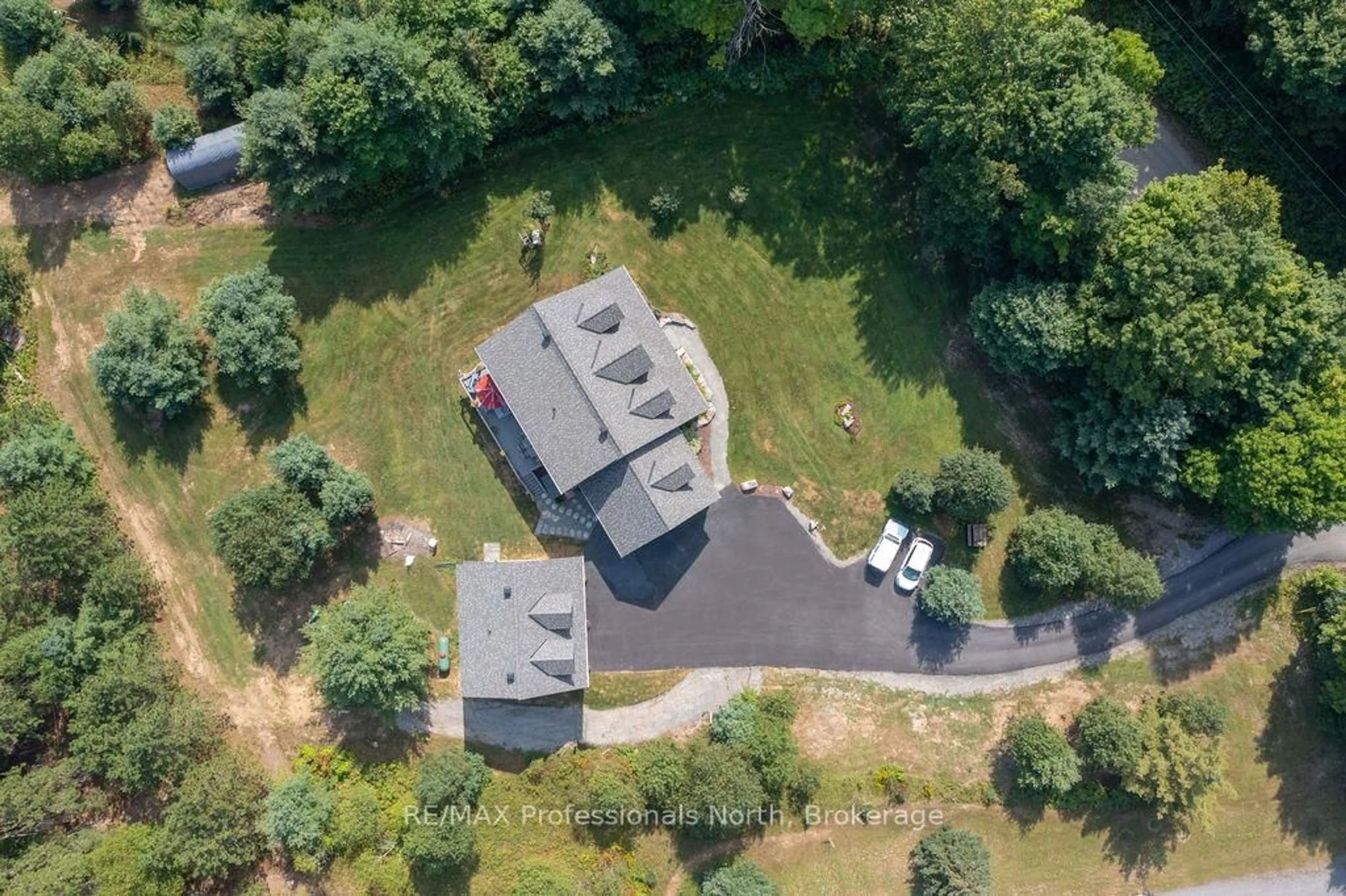 A pic from outside/outdoor area/front of a property/back of a property/a pic from drone, forest/trees view for 427 Skyhills Rd, Huntsville Ontario P1H 2N5
