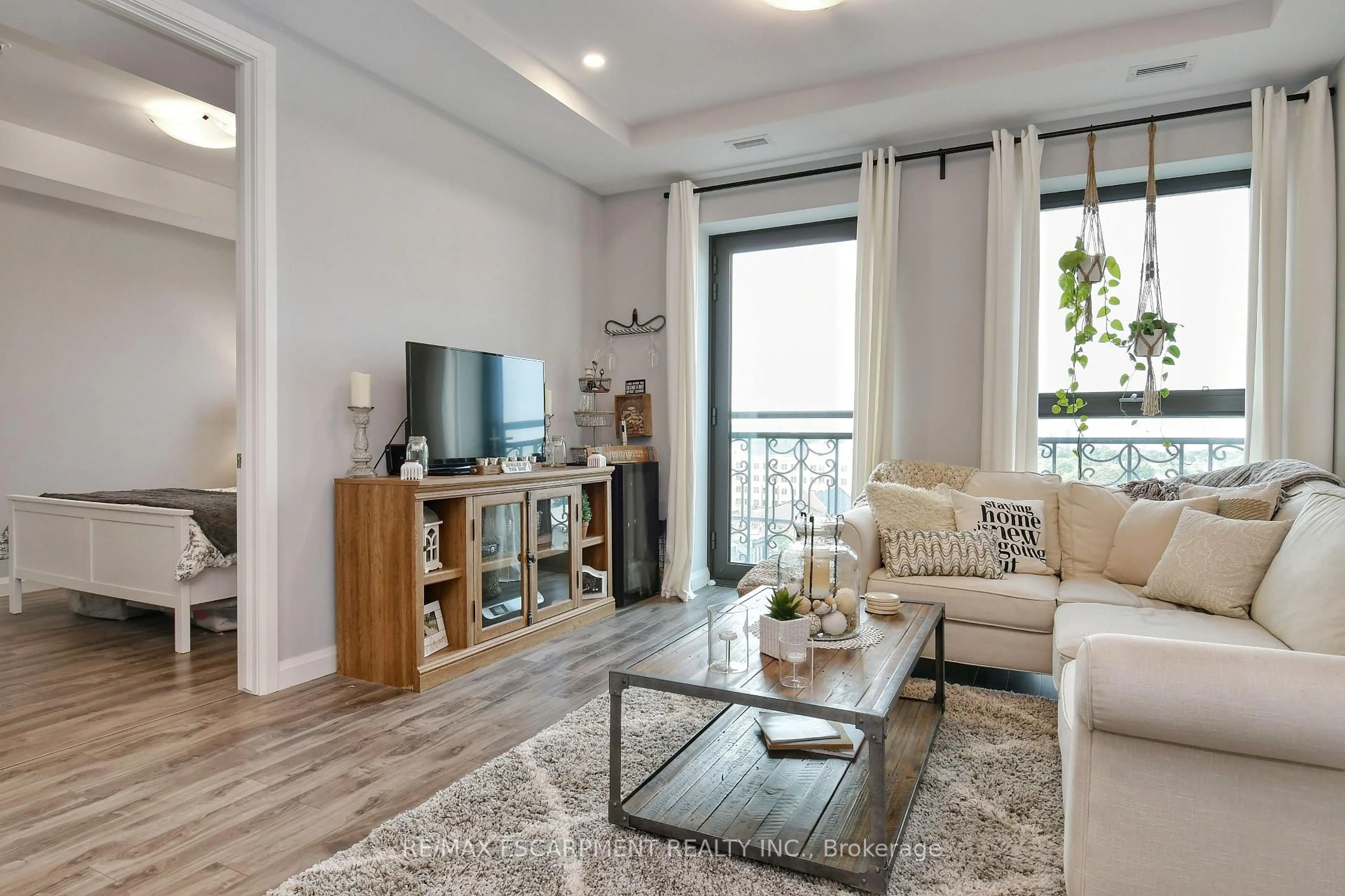Living room with furniture, wood/laminate floor for 112 King St #903, Hamilton Ontario L8N 1A8