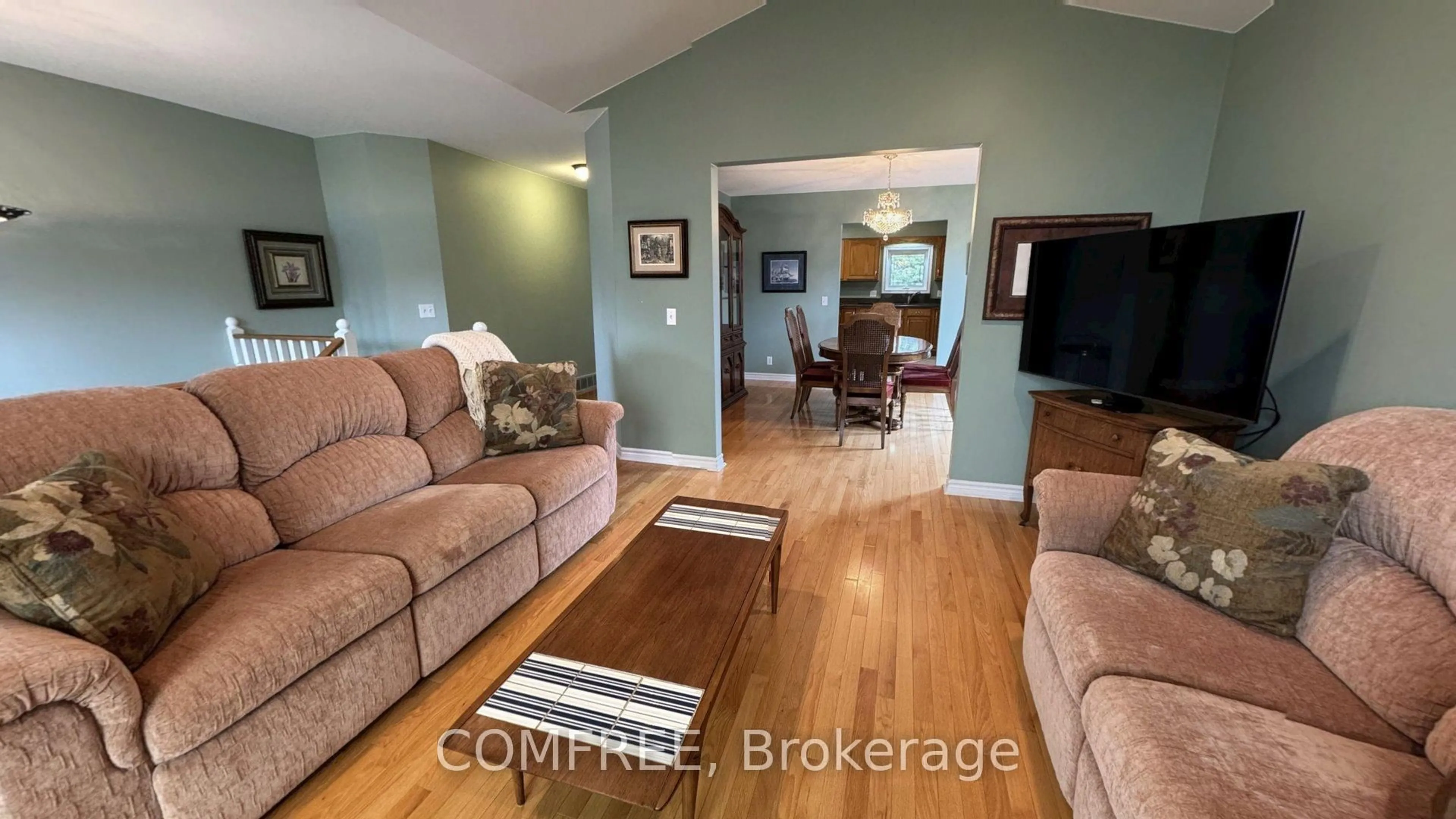 Living room with furniture, wood/laminate floor for 372 East Puce Rd, Lakeshore Ontario N8L 0C6