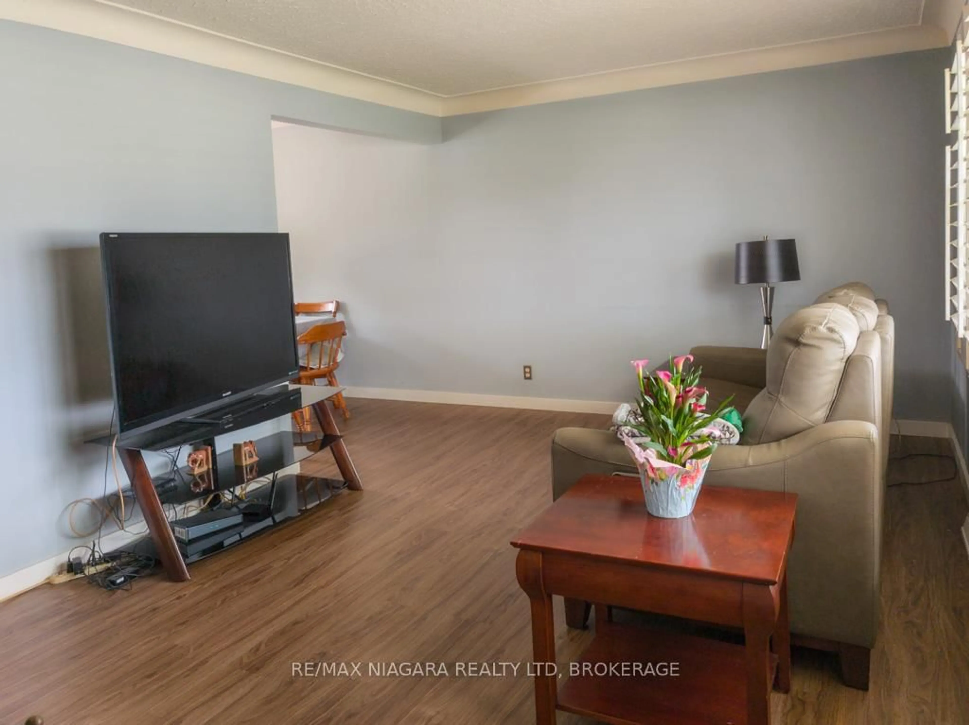Living room with furniture, wood/laminate floor for 6774 Glendoone St, Niagara Falls Ontario L2J 1G2
