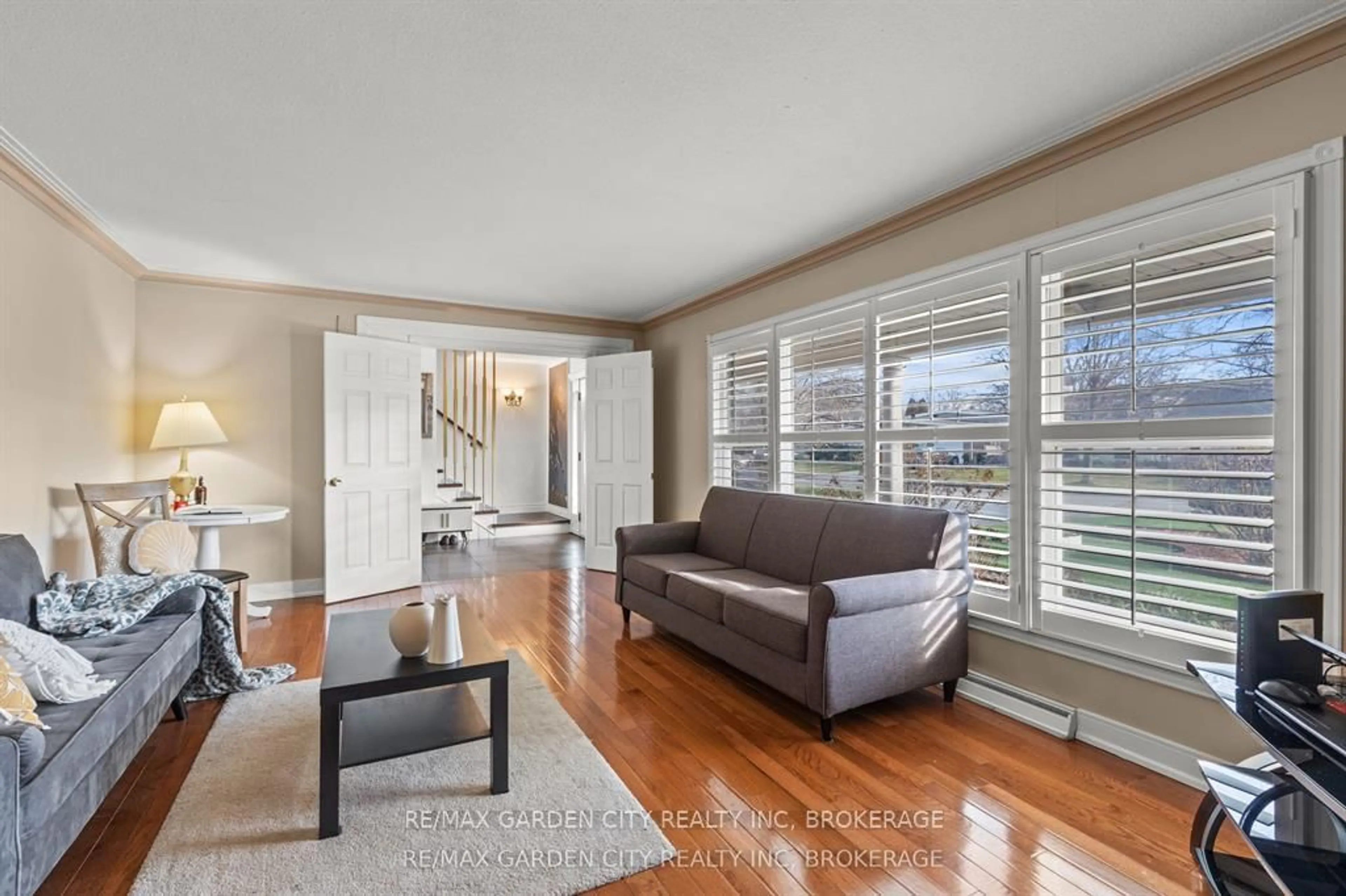 Living room with furniture, wood/laminate floor for 46 Adelene Cres, St. Catharines Ontario L2T 3C8
