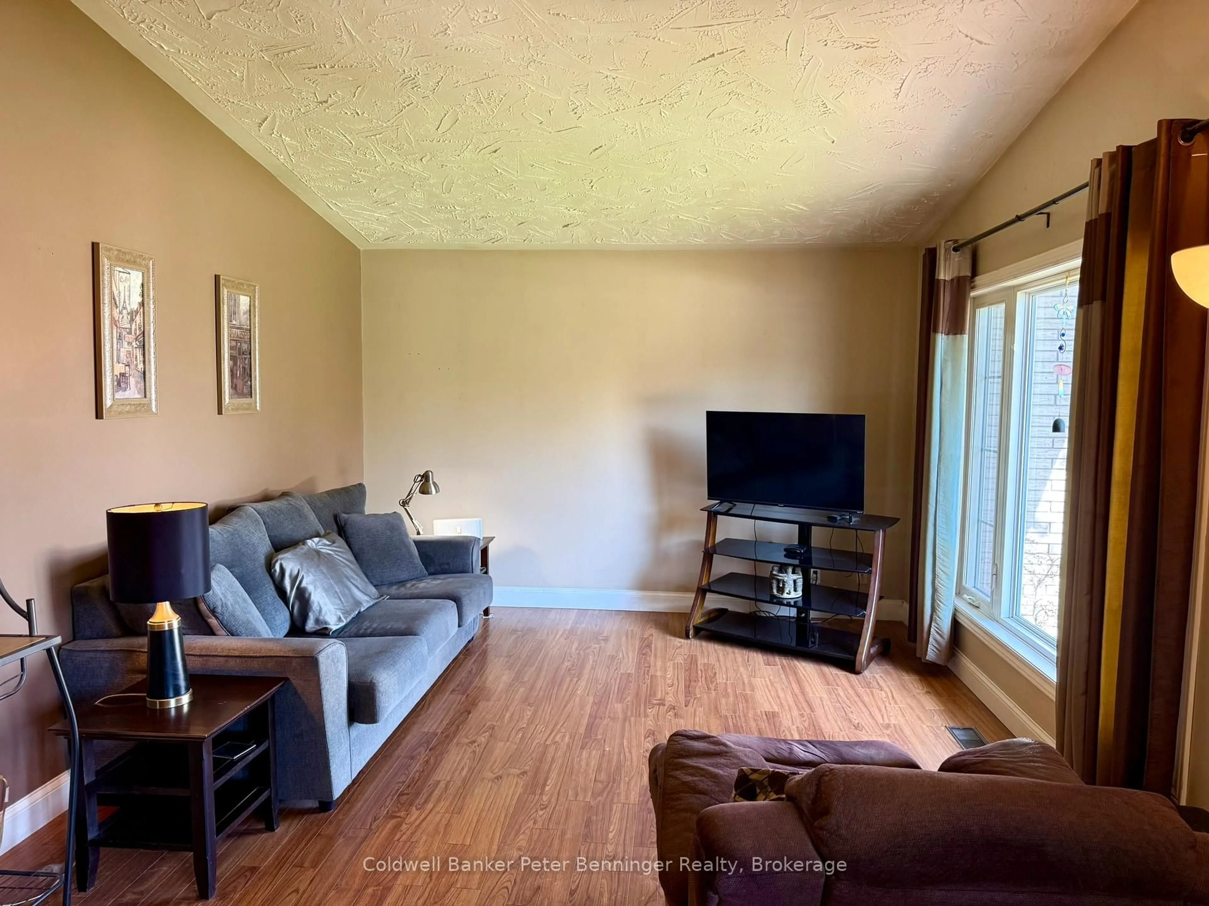Living room with furniture, wood/laminate floor for 25 Thomas St, South Bruce Ontario N0G 2S0
