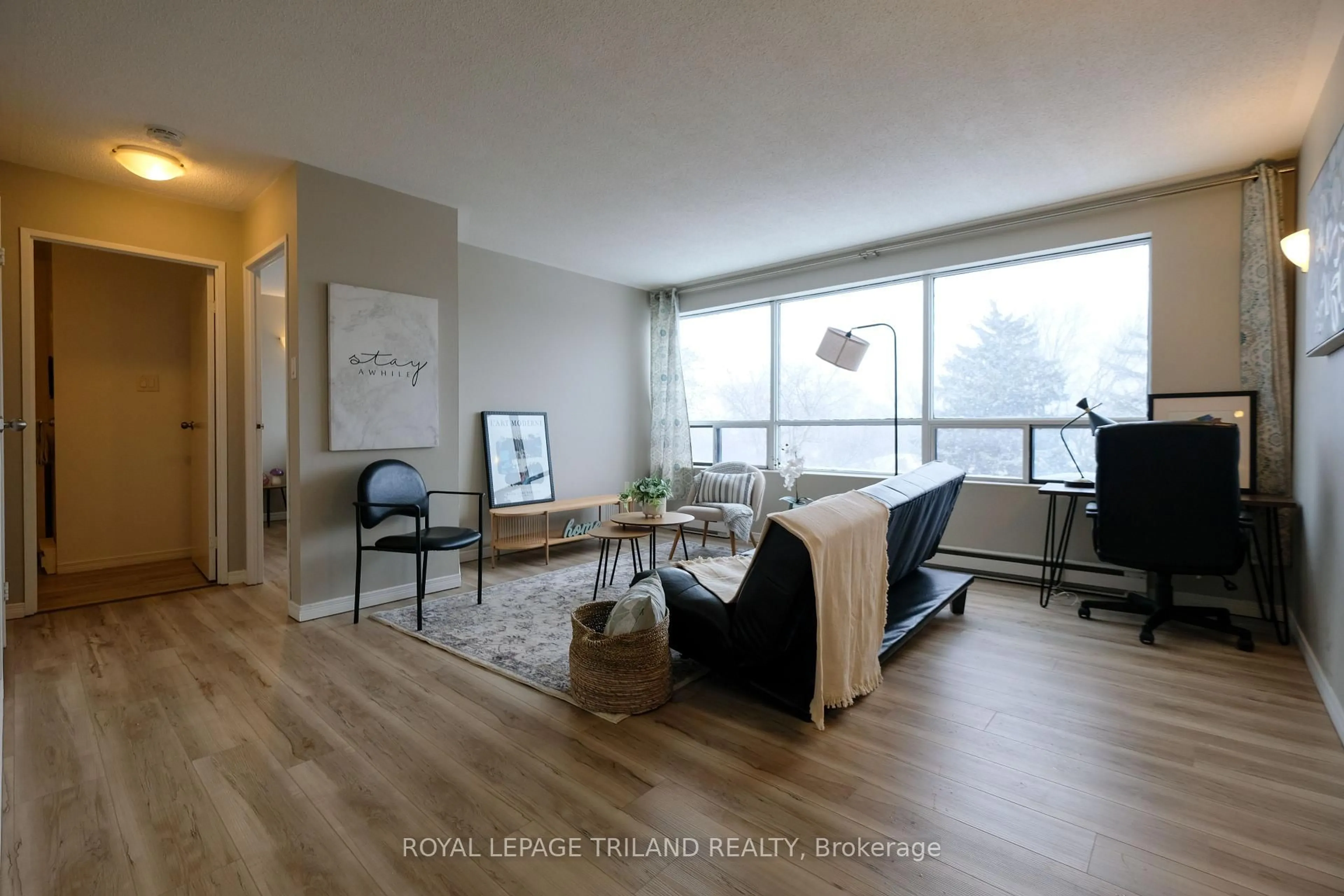 Living room with furniture, wood/laminate floor for 650 Cheapside St #605, London North Ontario N5Y 5J8