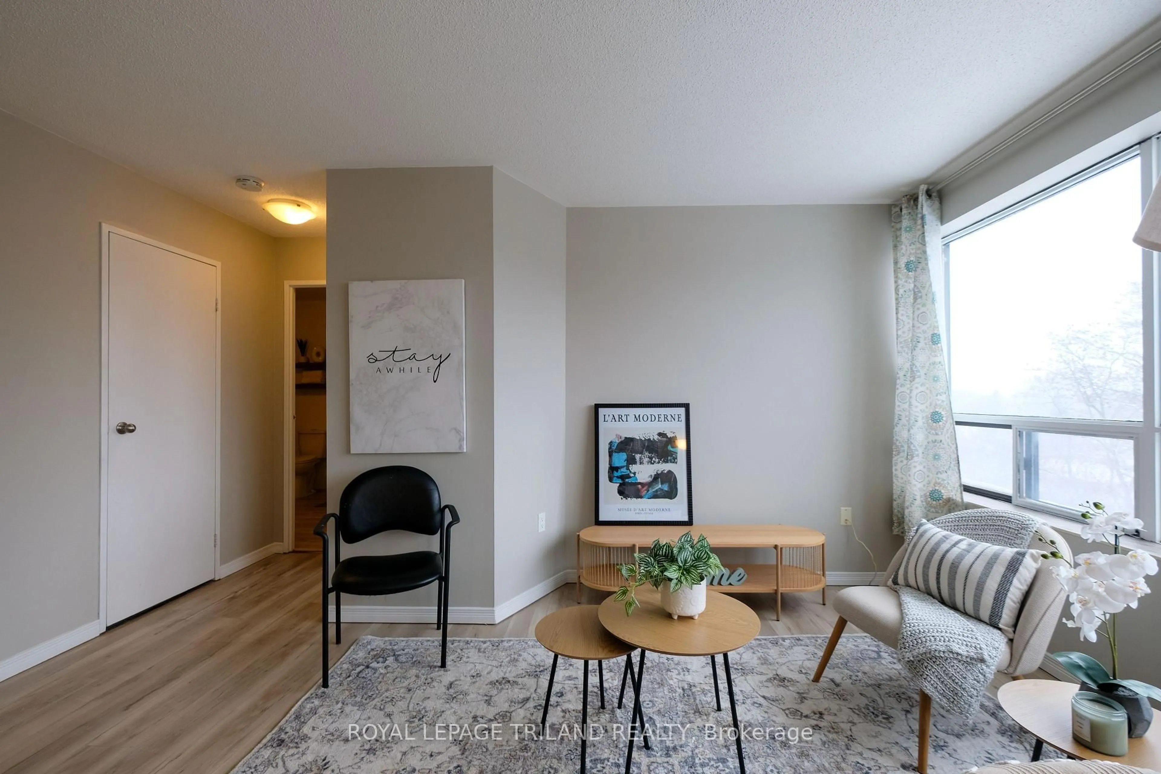 Living room with furniture, wood/laminate floor for 650 Cheapside St #605, London North Ontario N5Y 5J8