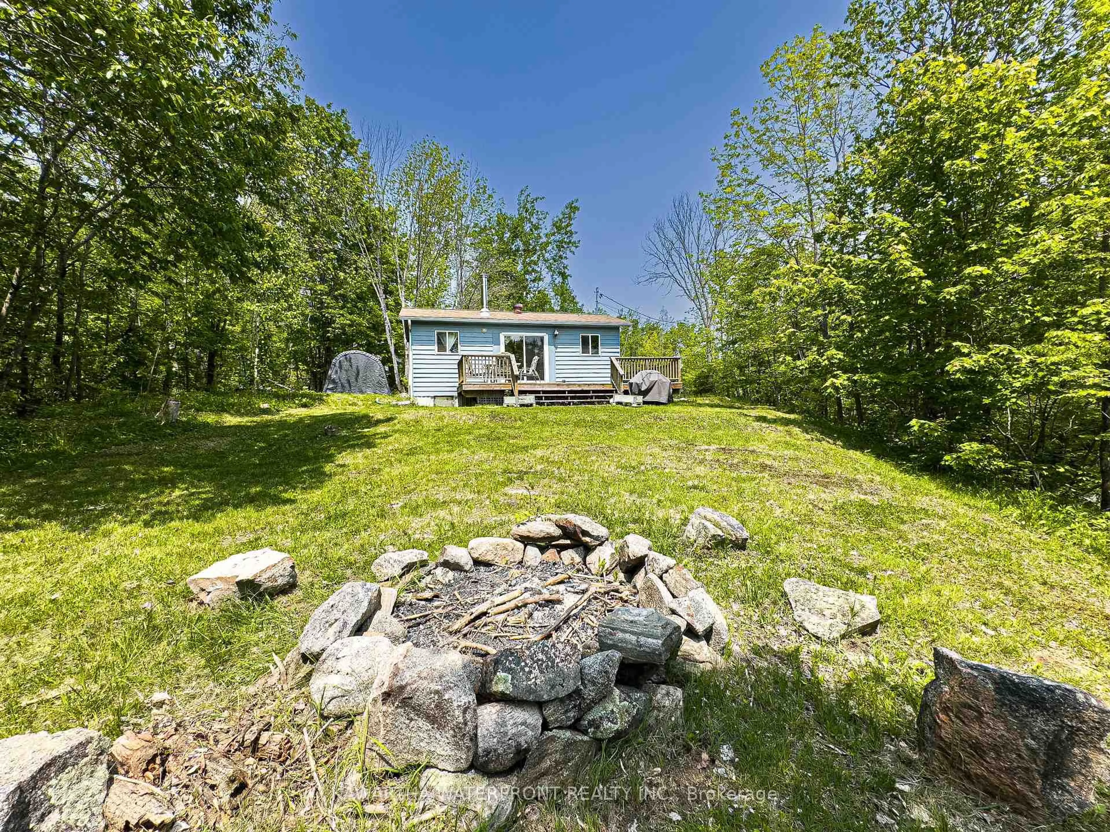 A pic from outside/outdoor area/front of a property/back of a property/a pic from drone, water/lake/river/ocean view for 1120 English Circ, Highlands East Ontario K0M 1R0