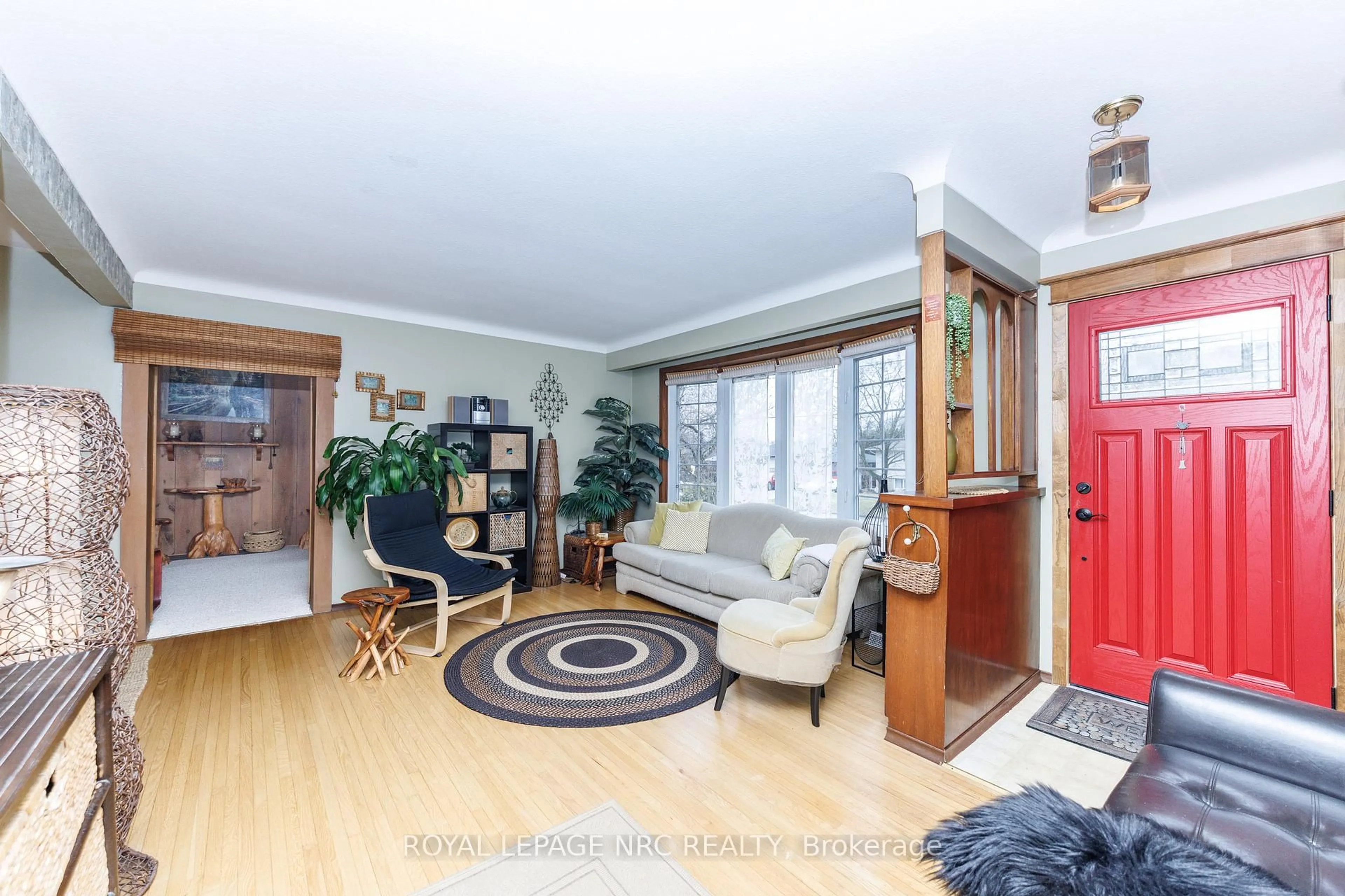 Living room with furniture, wood/laminate floor for 16 Rosemore Rd, St. Catharines Ontario L2S 1A8
