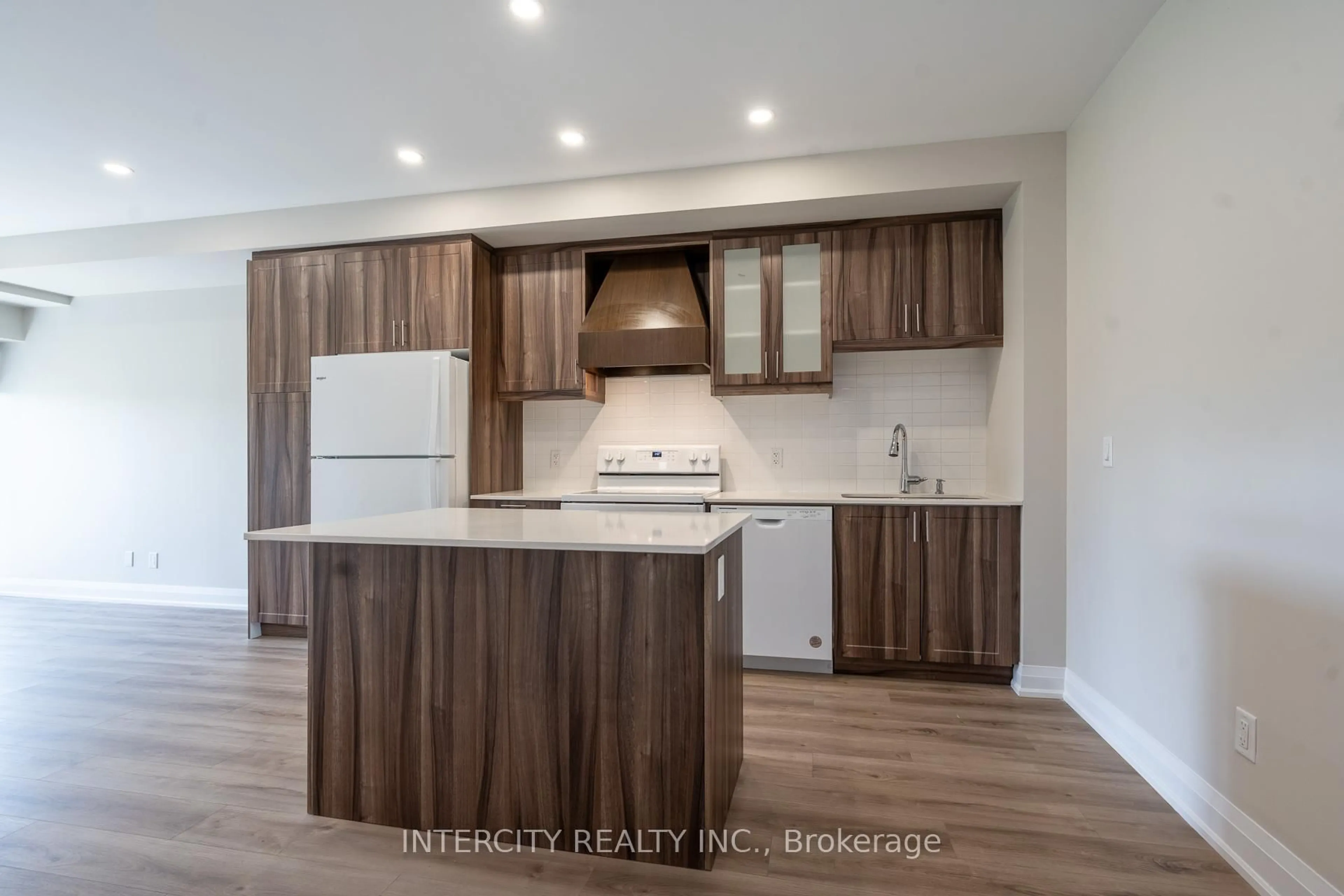 Open concept kitchen, wood/laminate floor for 50 Herrick Ave #327, St. Catharines Ontario L2P 2T9