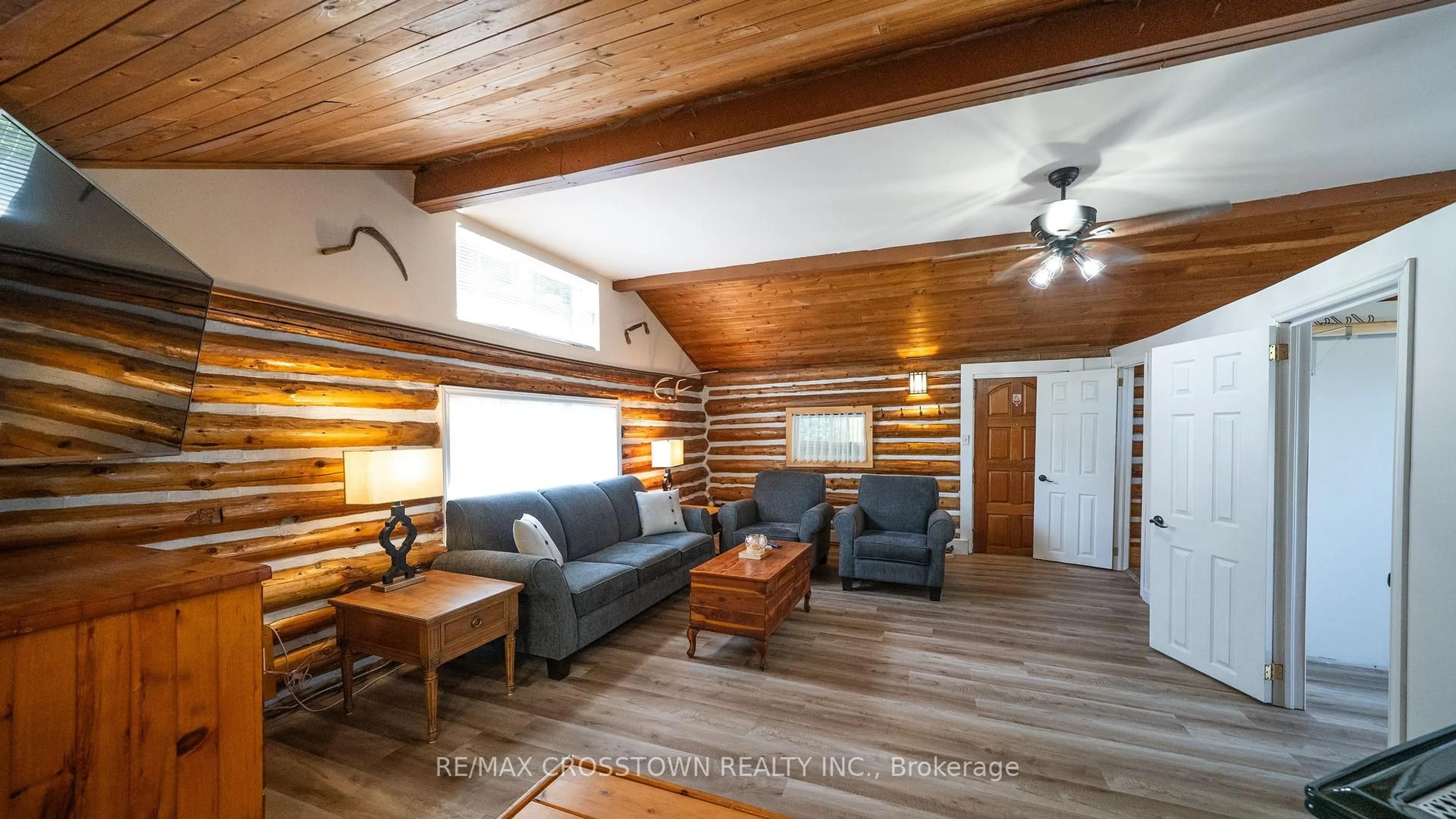 Living room with furniture, wood/laminate floor for 1161 Uffington Rd, Bracebridge Ontario P1L 1X1
