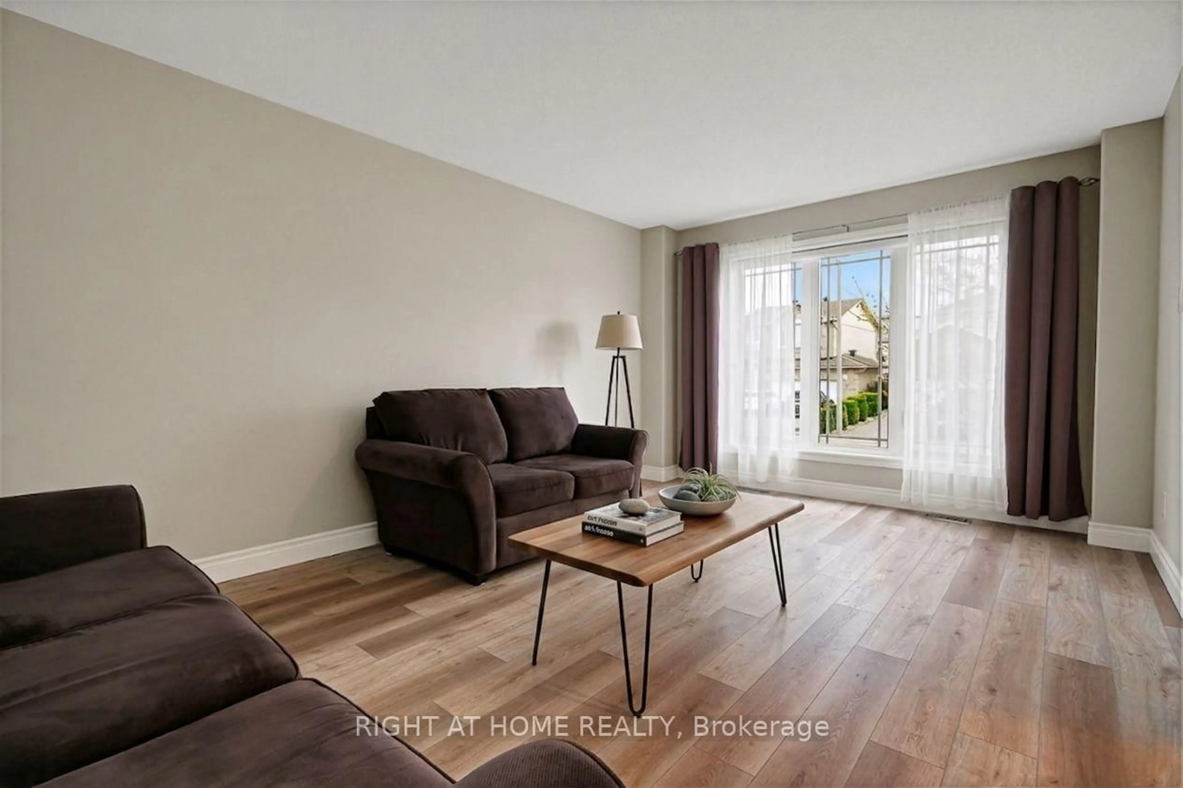 Living room with furniture, wood/laminate floor for 27 Manoir St, Russell Ontario K0A 1W0