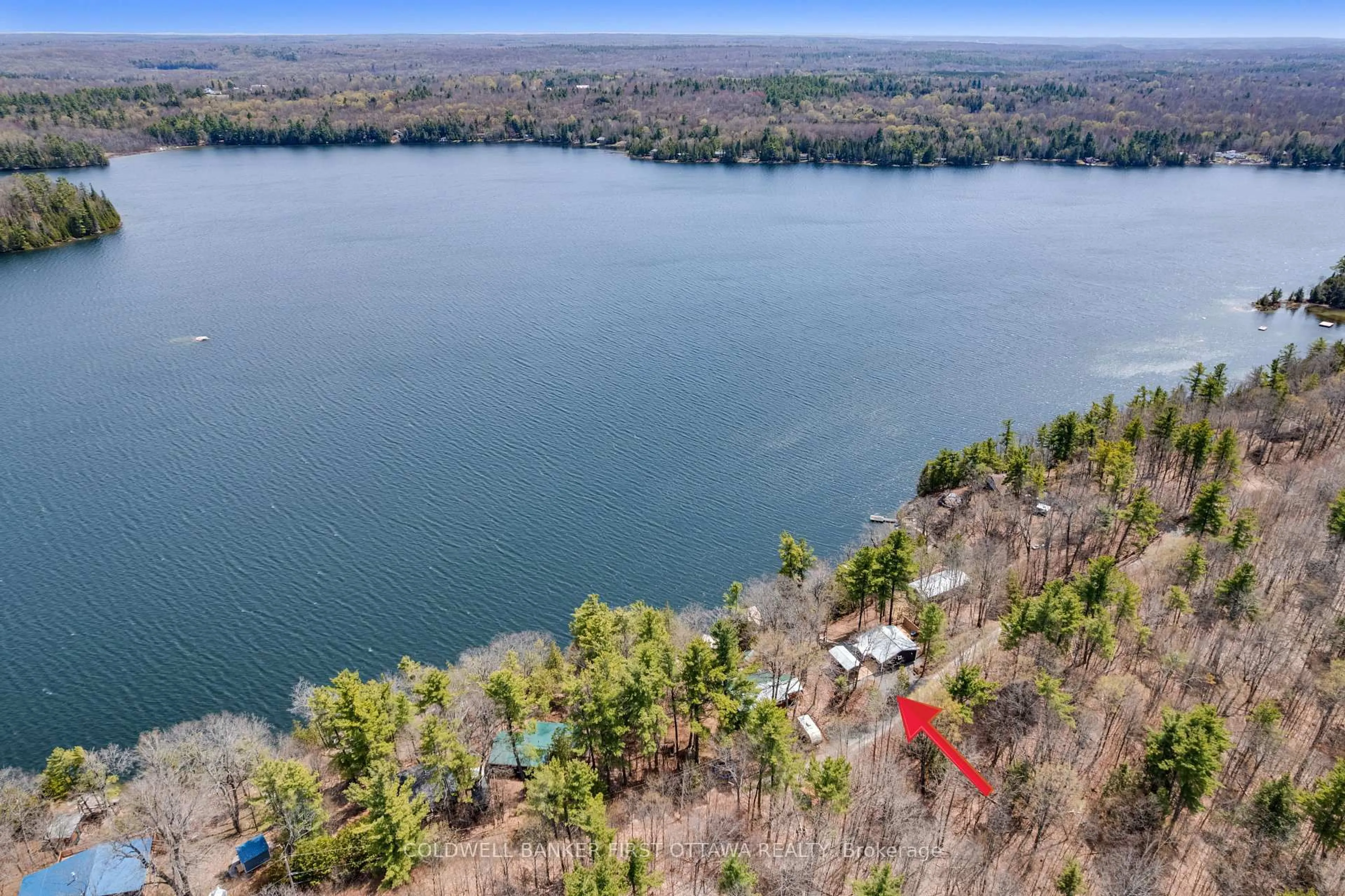 A pic from outside/outdoor area/front of a property/back of a property/a pic from drone, water/lake/river/ocean view for 119 Farren Lake Lane 22, Maberly Ontario K0H 2B0