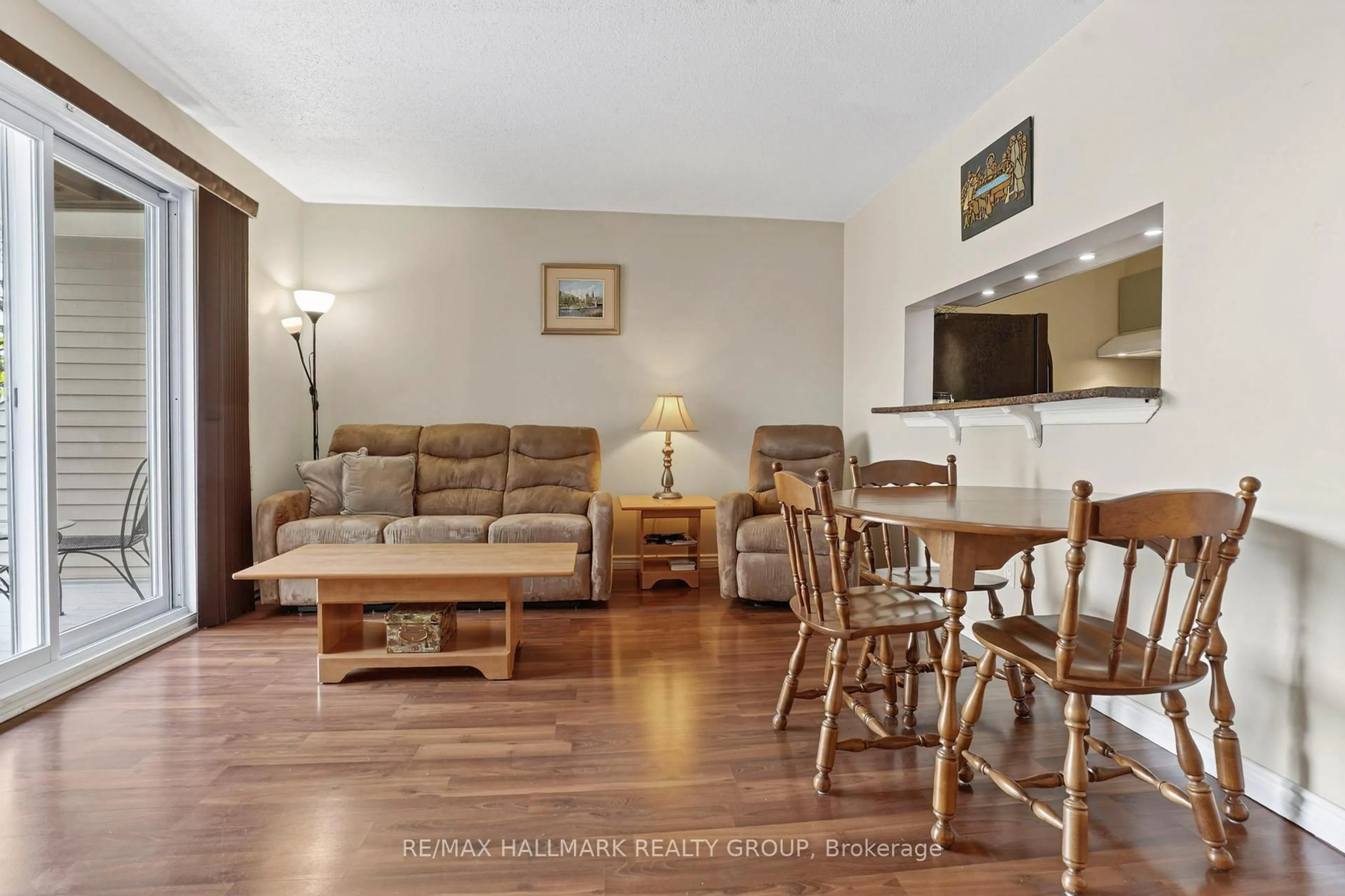 Living room with furniture, wood/laminate floor for 270 Brittany Dr #214, Ottawa Ontario K1K 4M3
