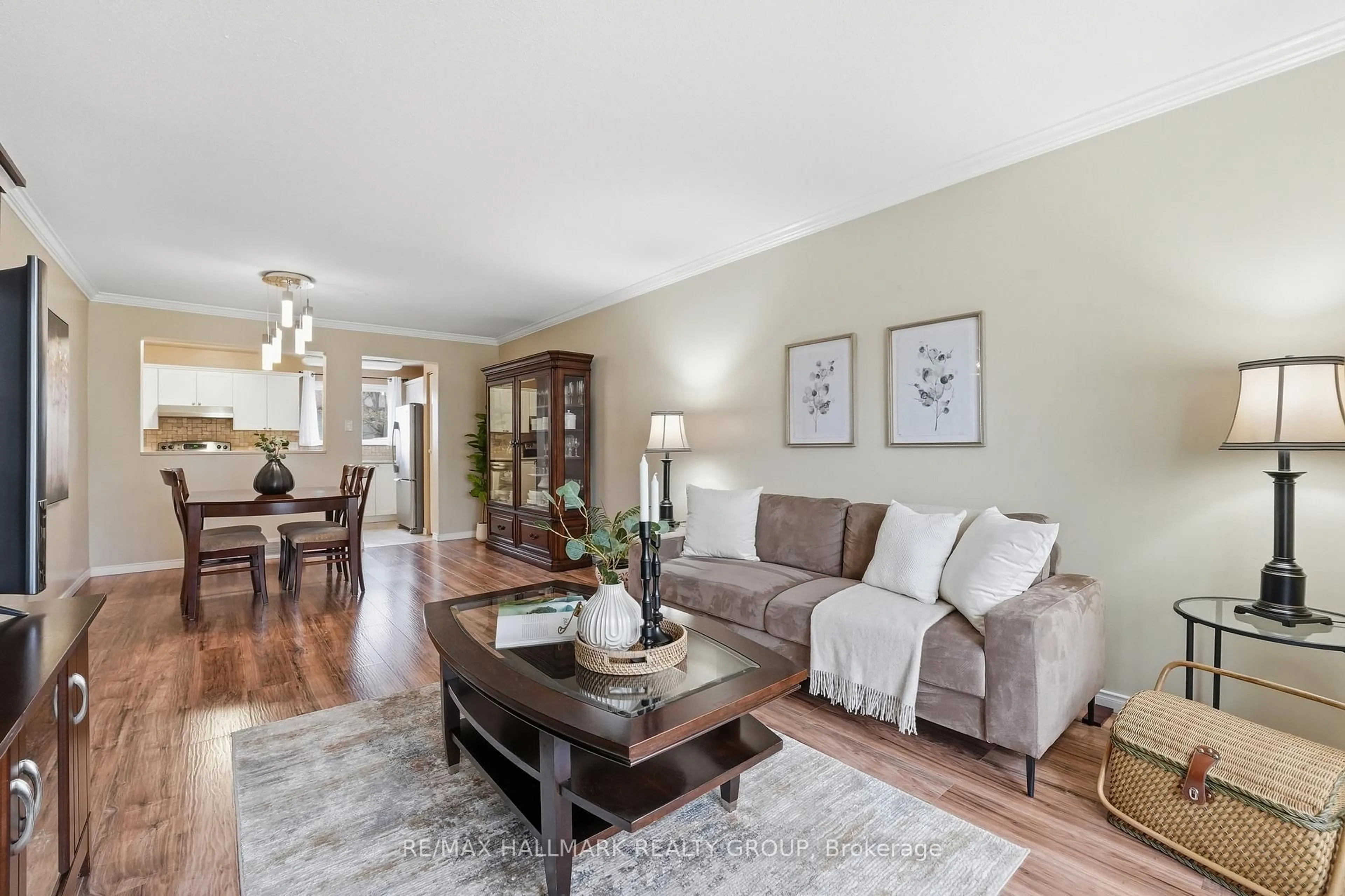 Living room with furniture, wood/laminate floor for 2336 Orient Park Dr #59, Ottawa Ontario K1B 4N5
