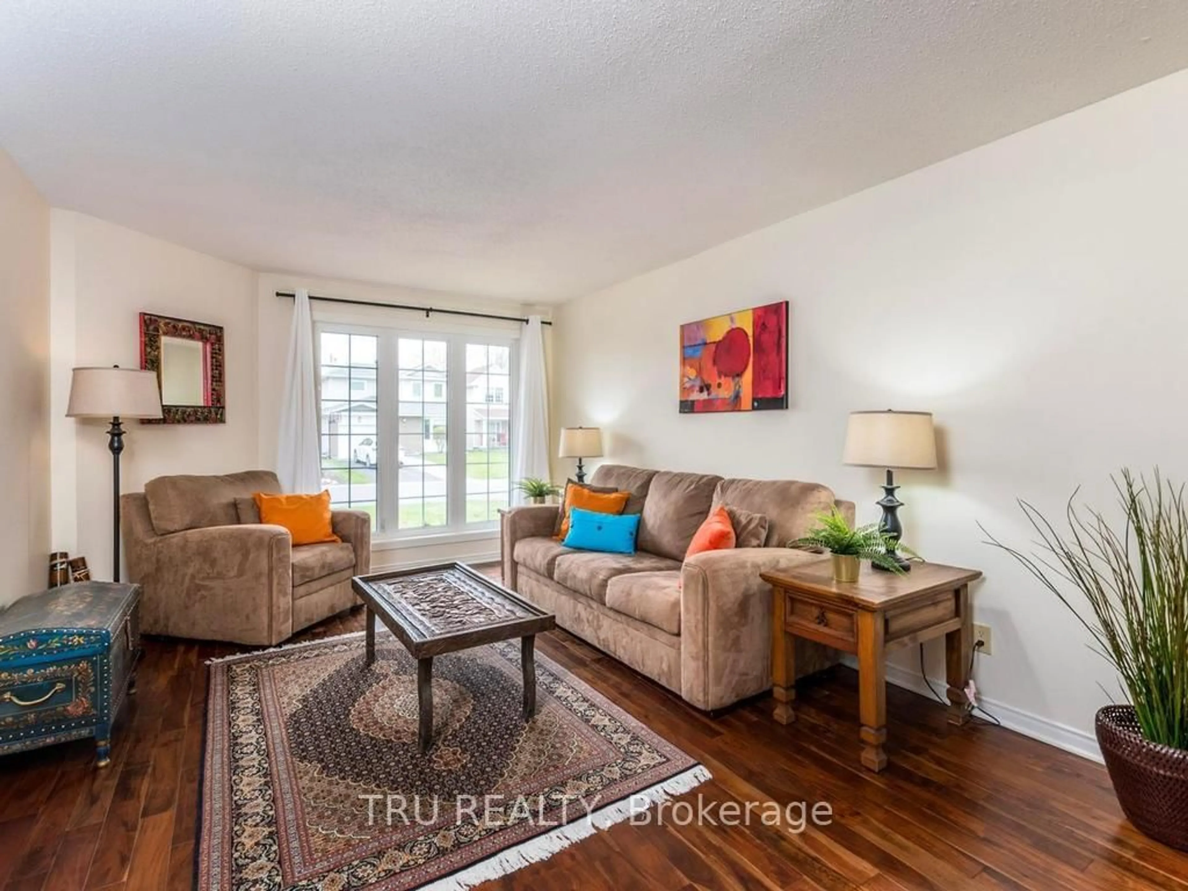 Living room with furniture, wood/laminate floor for 14 Hyannis Ave, Ottawa Ontario K2J 2W8