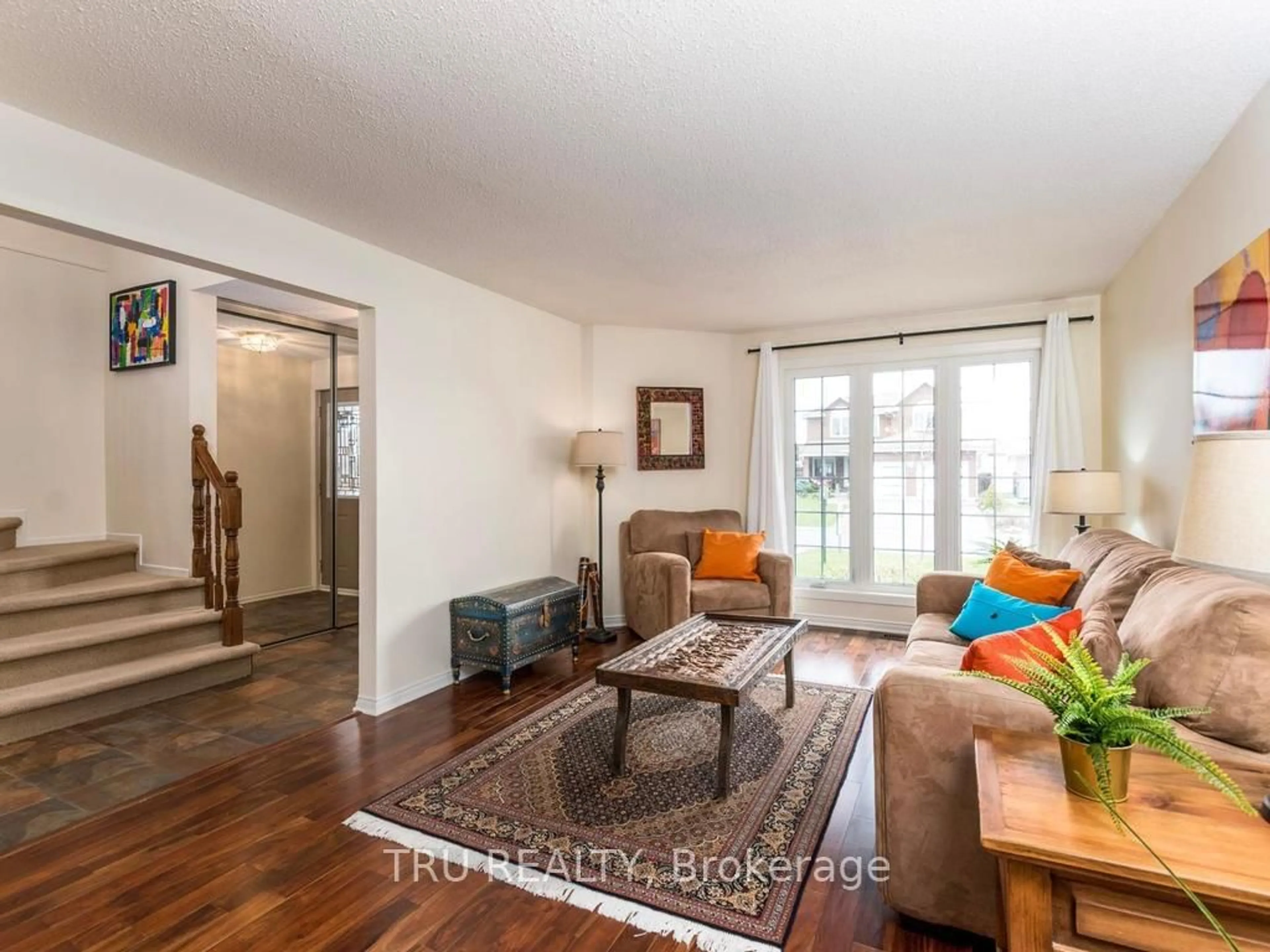 Living room with furniture, wood/laminate floor for 14 Hyannis Ave, Ottawa Ontario K2J 2W8