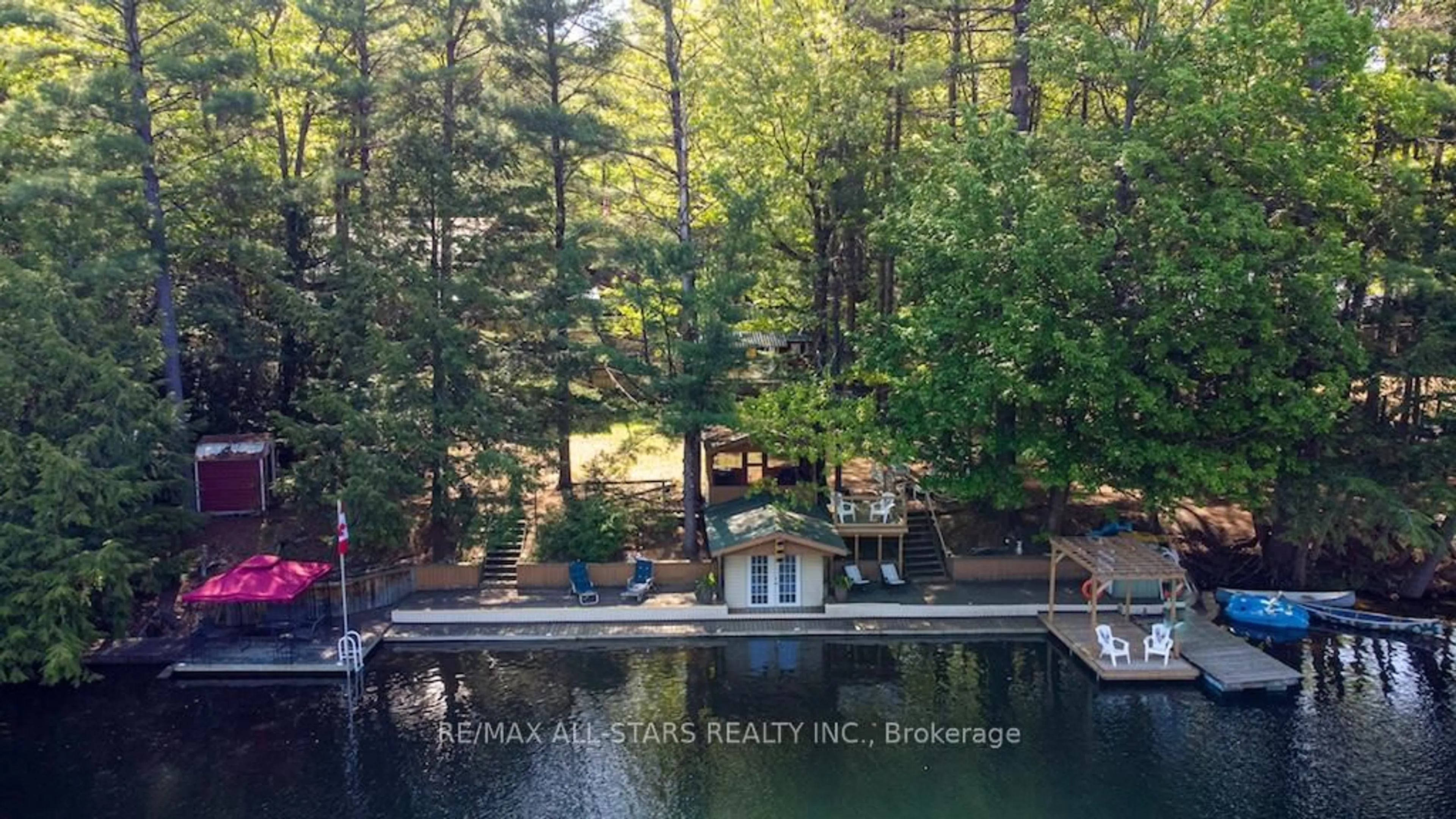 A pic from outside/outdoor area/front of a property/back of a property/a pic from drone, water/lake/river/ocean view for 1130 Towering Oaks Dr, Minden Hills Ontario K0M 2L0