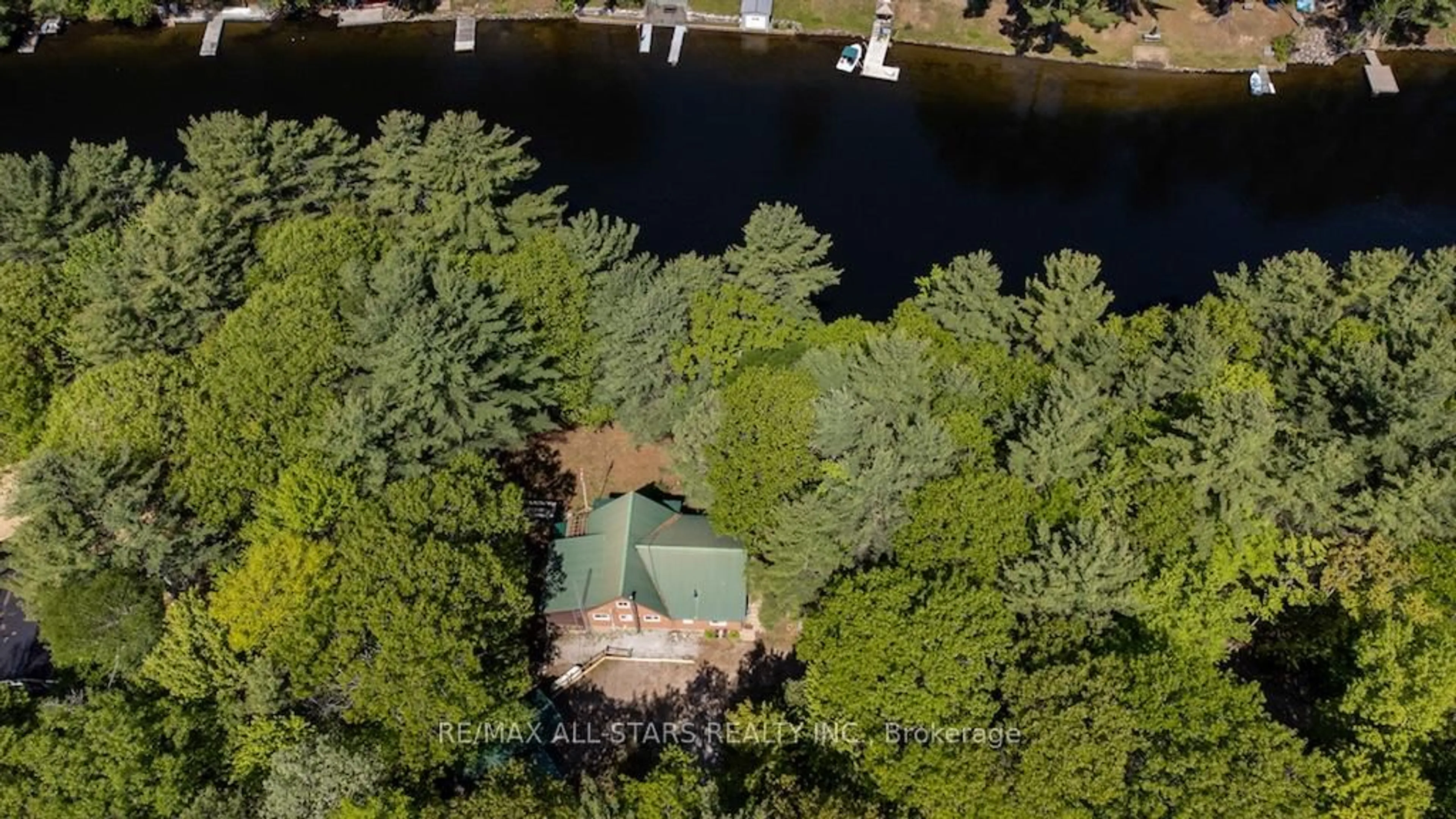 A pic from outside/outdoor area/front of a property/back of a property/a pic from drone, water/lake/river/ocean view for 1130 Towering Oaks Dr, Minden Hills Ontario K0M 2L0