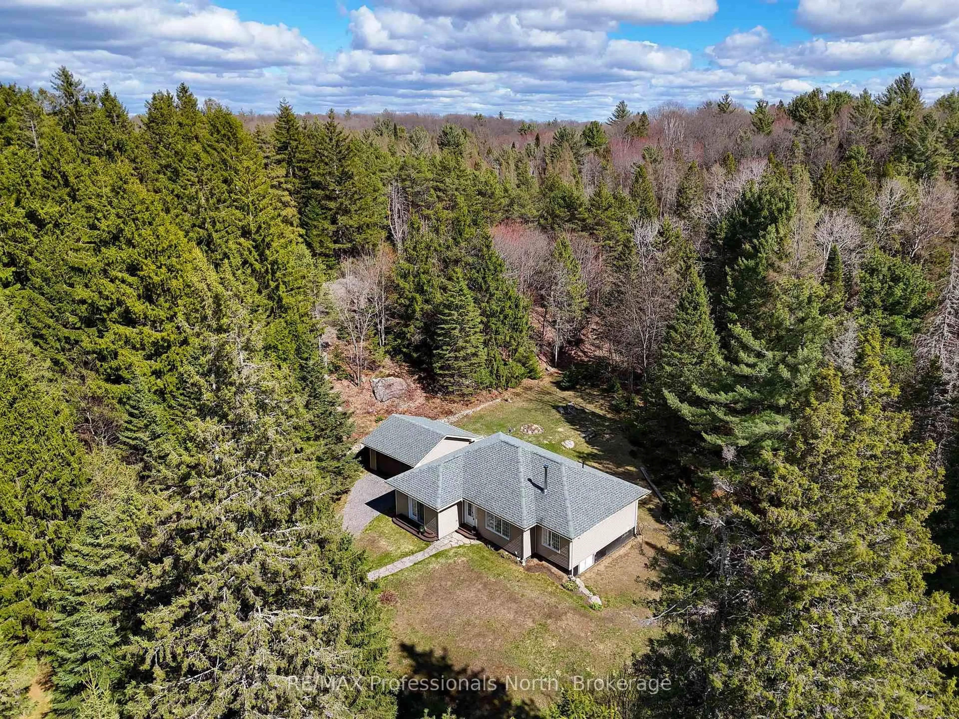 A pic from outside/outdoor area/front of a property/back of a property/a pic from drone, forest/trees view for 2253 Lone Pine Dr, Huntsville Ontario P0B 1L0