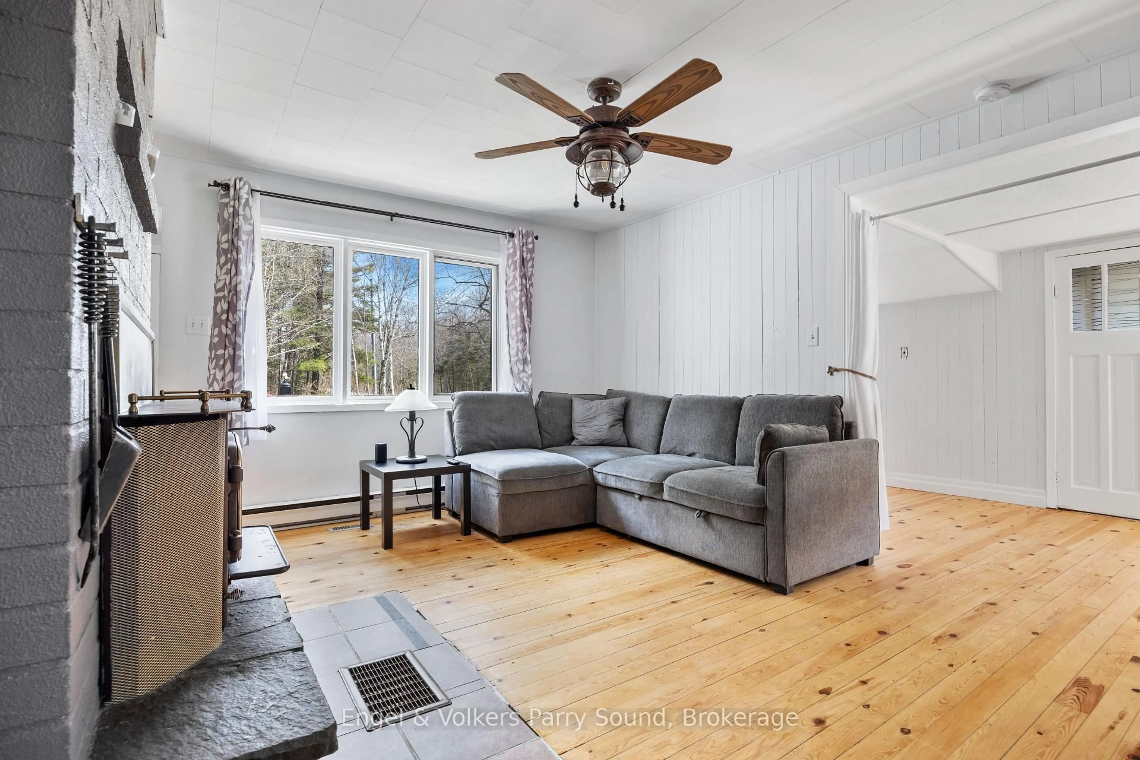 Living room with furniture, wood/laminate floor for 77 Woods Rd, Carling Ontario P0G 1G0