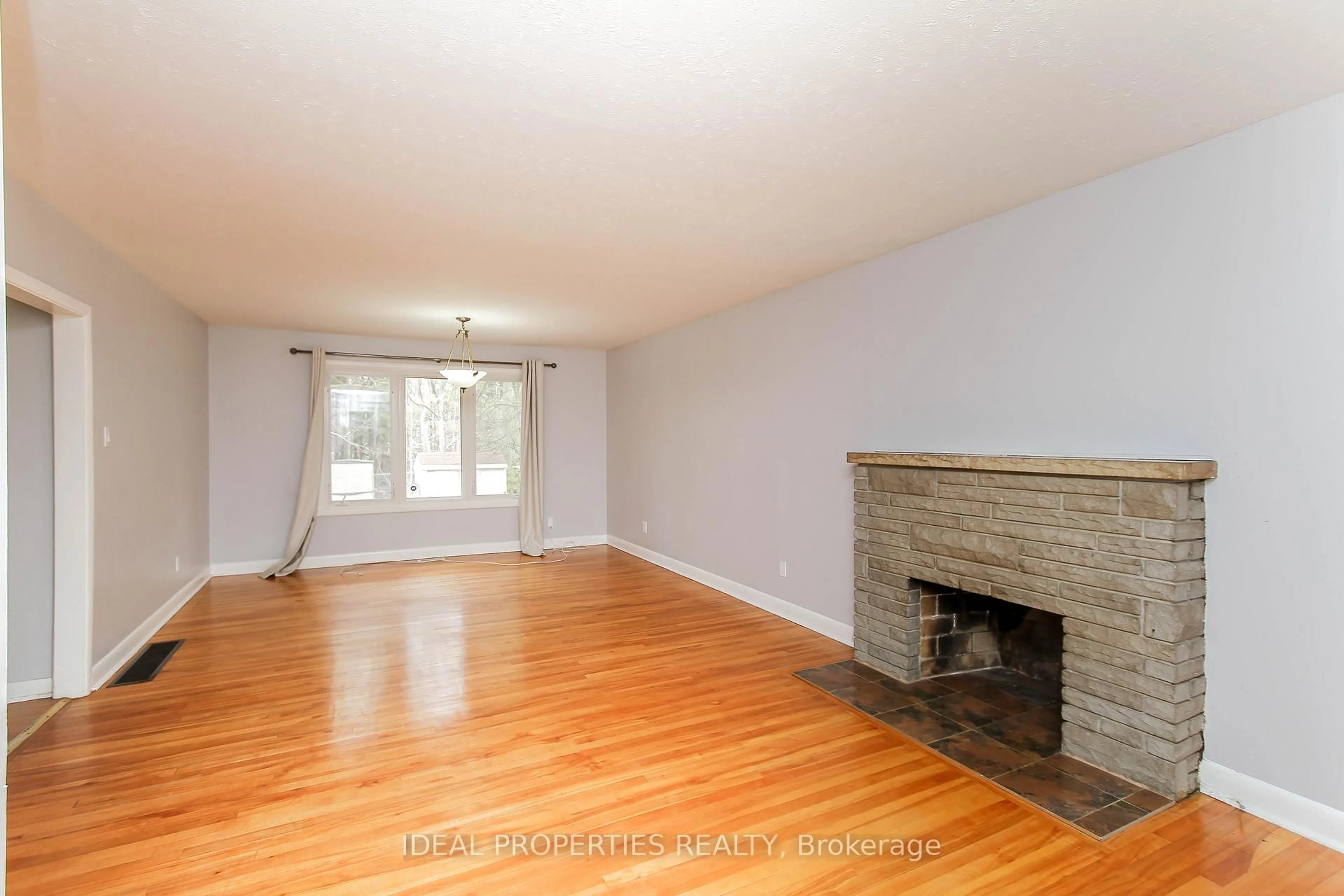 Living room with furniture, wood/laminate floor for 1217 Parkway Dr, Ottawa Ontario K2C 2W5