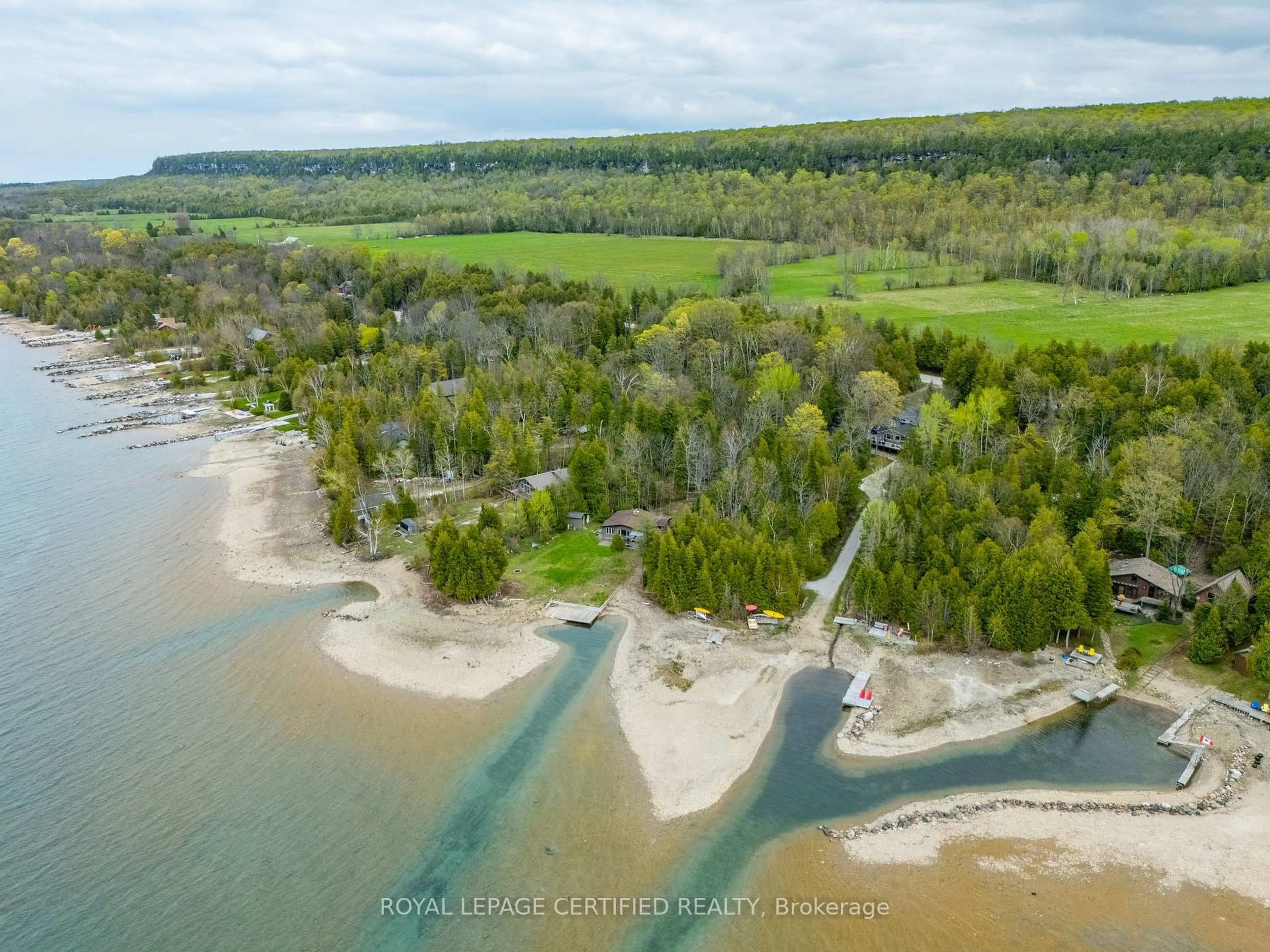 A pic from outside/outdoor area/front of a property/back of a property/a pic from drone, water/lake/river/ocean view for 502495 Grey Road 1, Georgian Bluffs Ontario N0H 2T0
