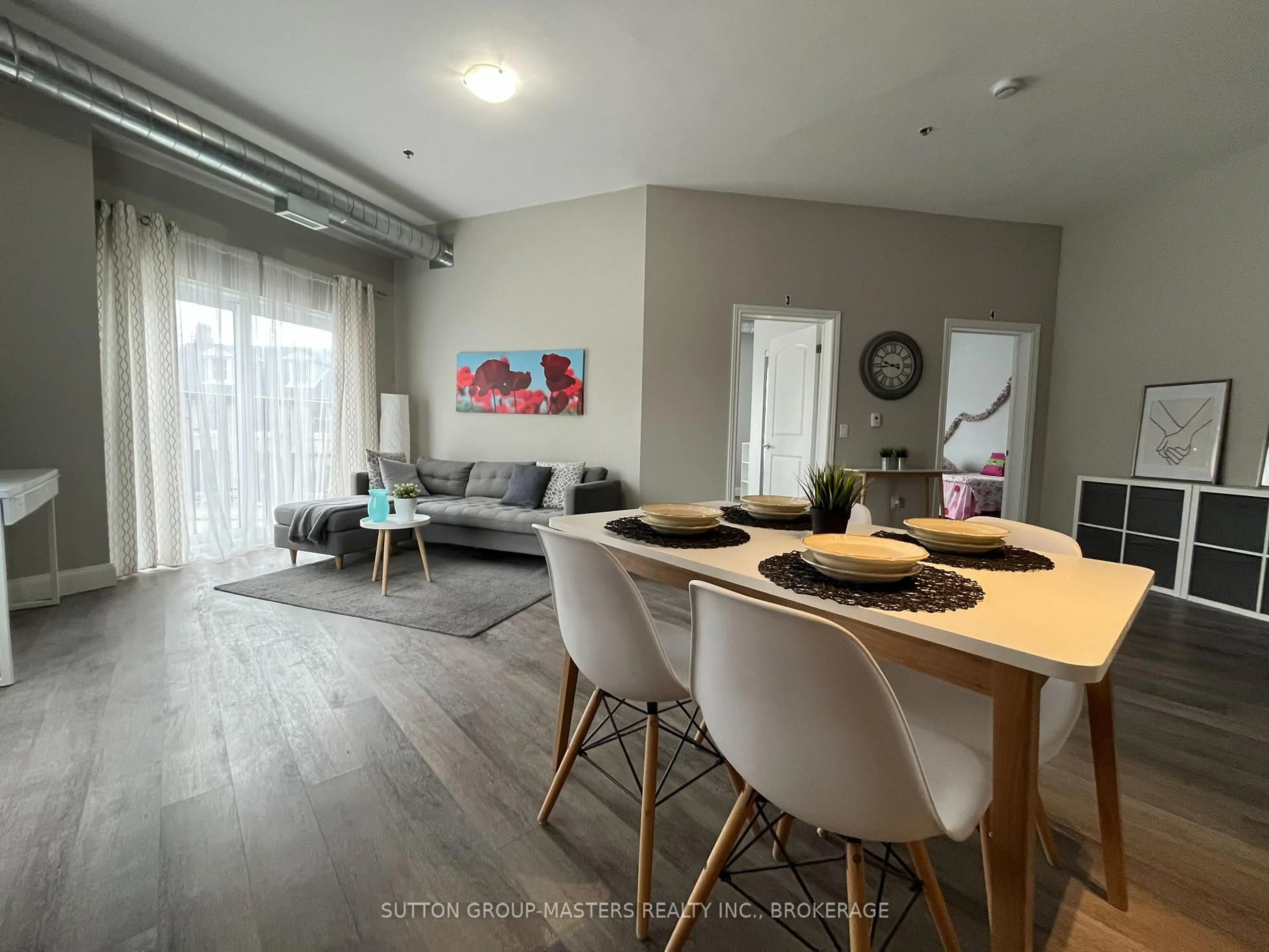 Living room with furniture, wood/laminate floor for 630 Princess St #201, Kingston Ontario K7L 1E3