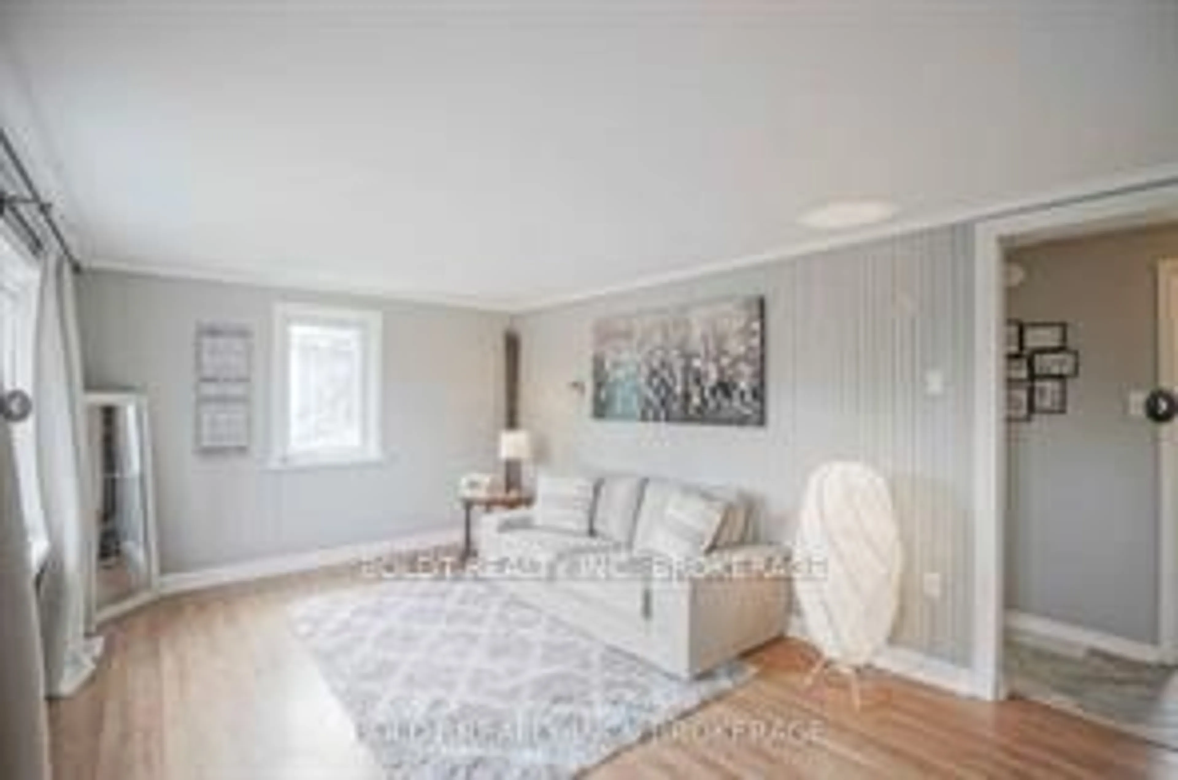 Living room with furniture, wood/laminate floor for 61 Bradley St, St. Catharines Ontario L3T 1R5