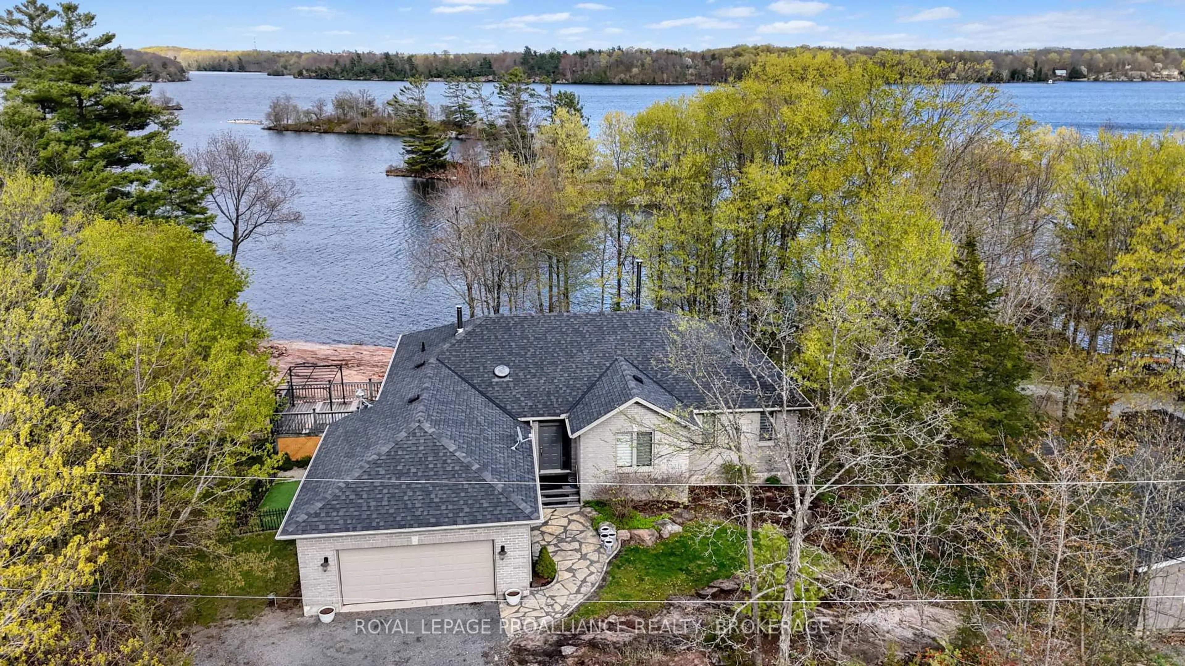 A pic from outside/outdoor area/front of a property/back of a property/a pic from drone, water/lake/river/ocean view for 4194C Hiawatha Lane, Battersea Ontario K0H 1H0