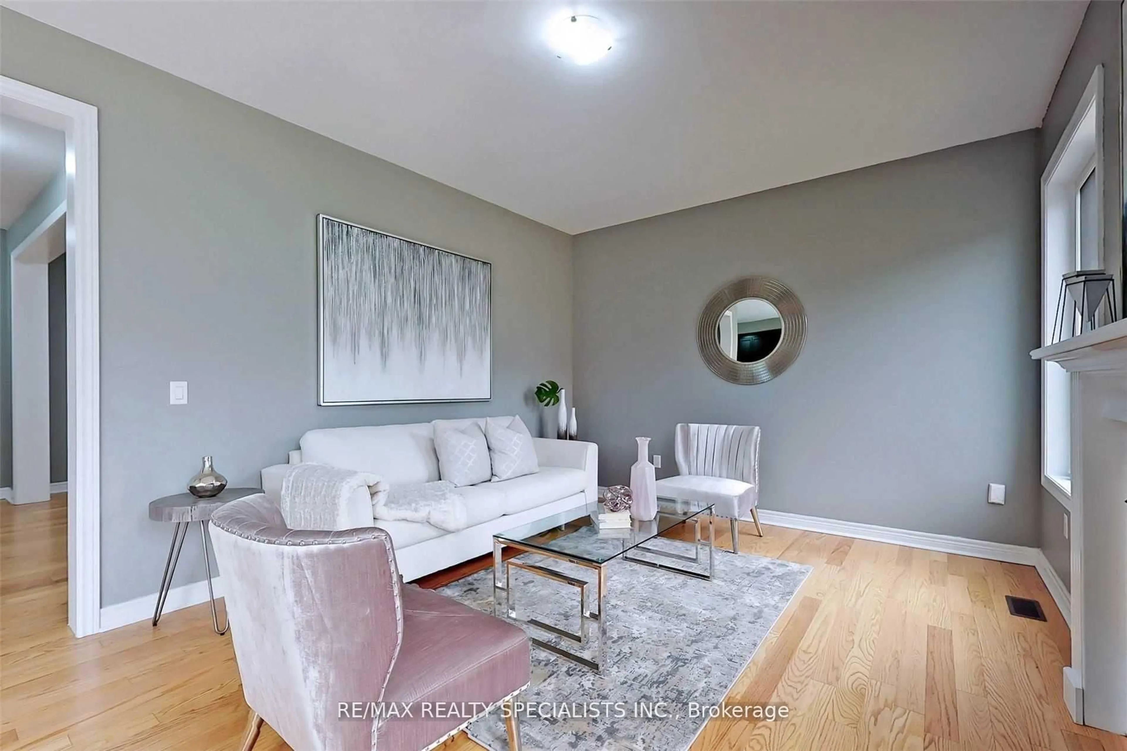 Living room with furniture, wood/laminate floor for 1191 Upper Thames Dr, Woodstock Ontario N4T 0L3