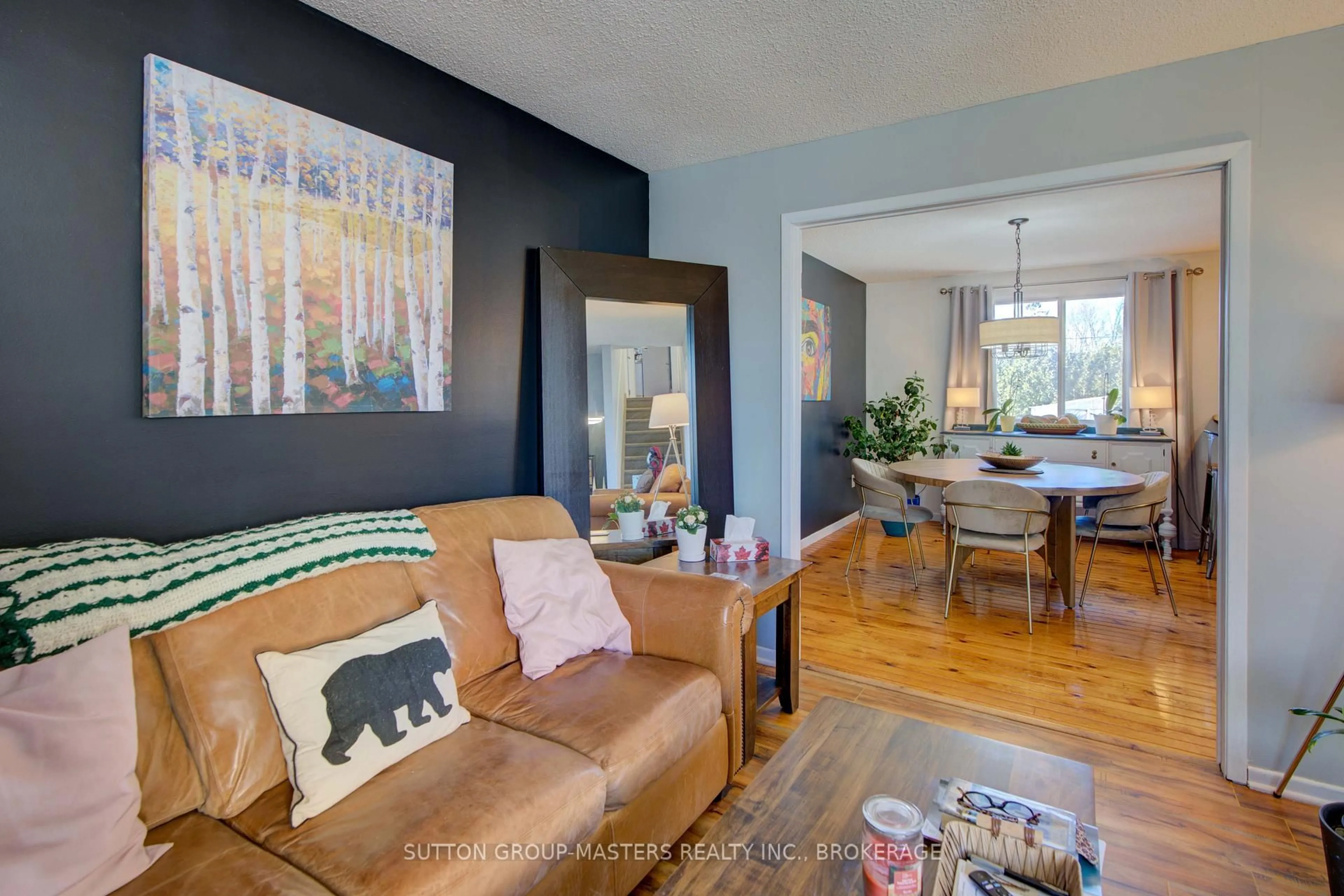 Living room with furniture, wood/laminate floor for 715 Collins Bay Rd, Kingston Ontario K7M 5H1