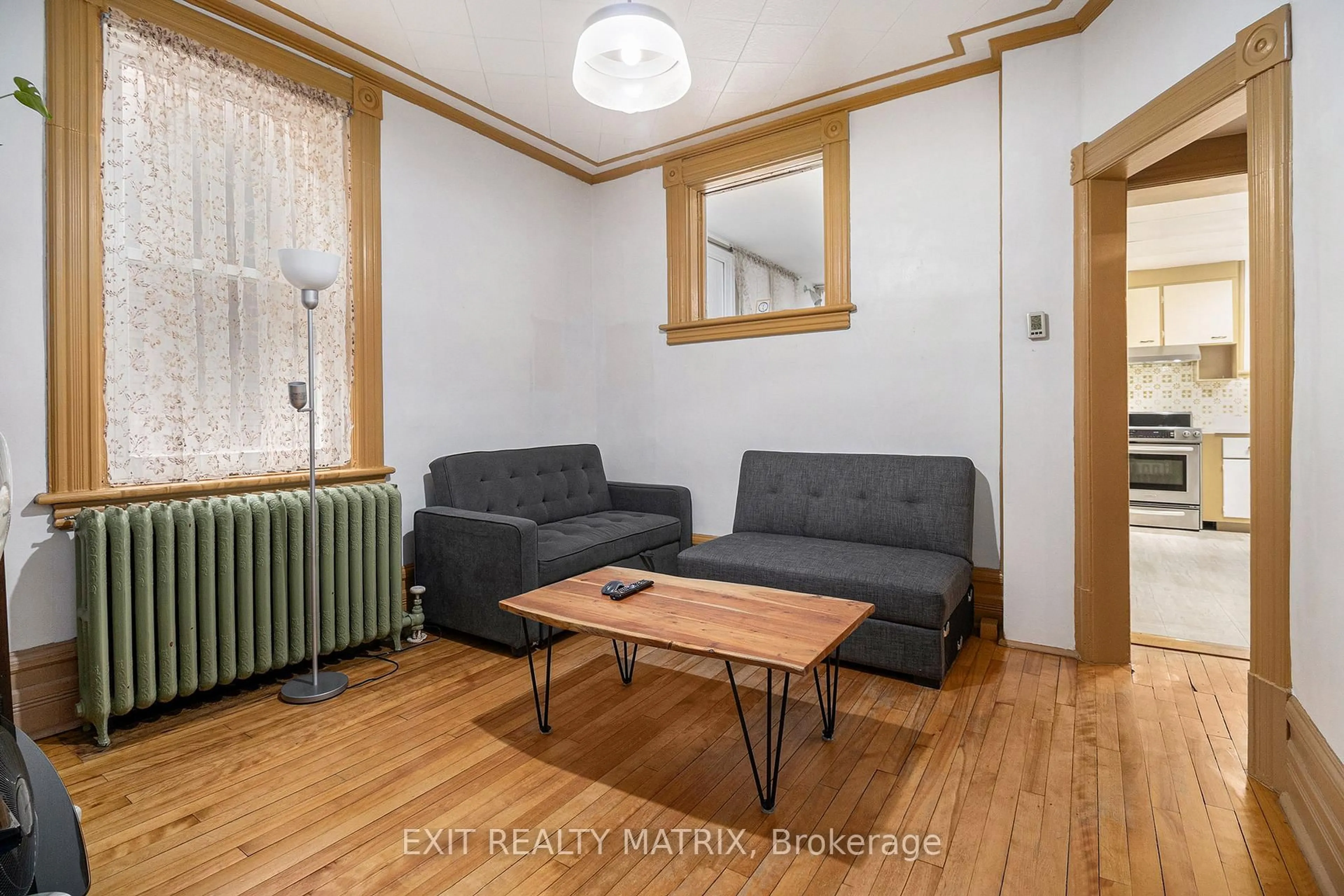 Living room with furniture, wood/laminate floor for 14 Somerset St, Ottawa Ontario K2P 0H4
