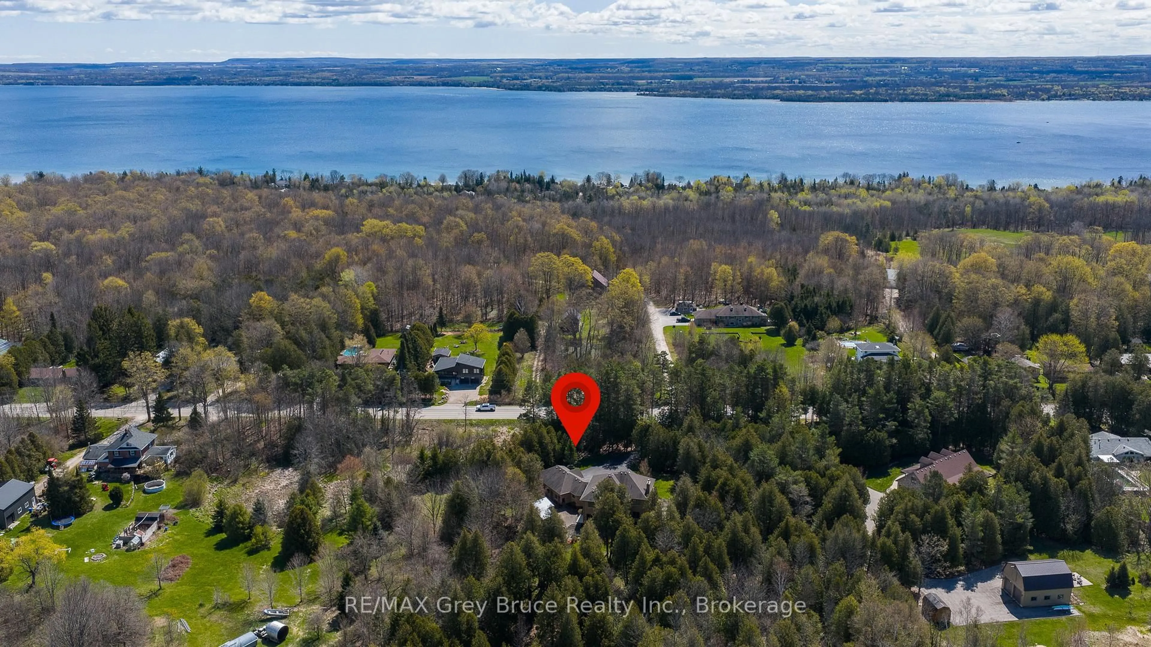 A pic from outside/outdoor area/front of a property/back of a property/a pic from drone, water/lake/river/ocean view for 318760 Grey Road 1, Georgian Bluffs Ontario N4K 5N4