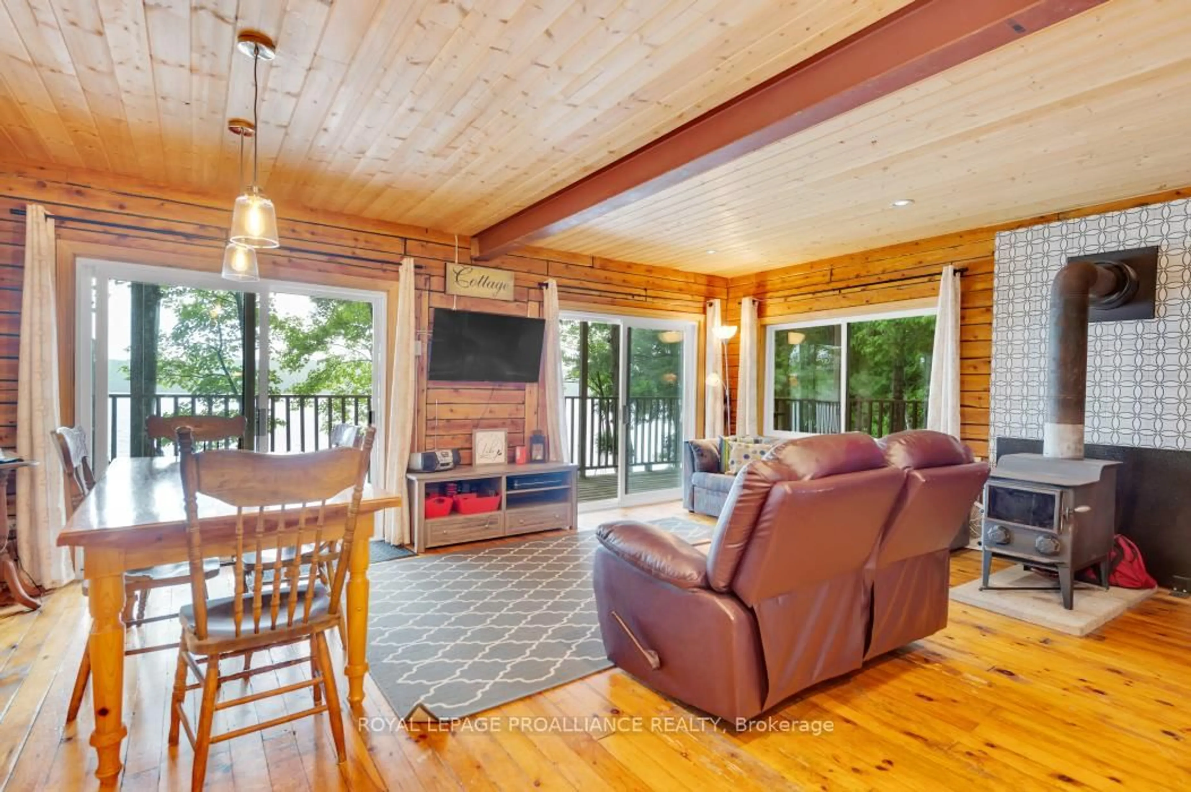 Living room with furniture, wood/laminate floor for 10520 Mazinaw Lake Access, Cloyne Ontario K0H 1K0