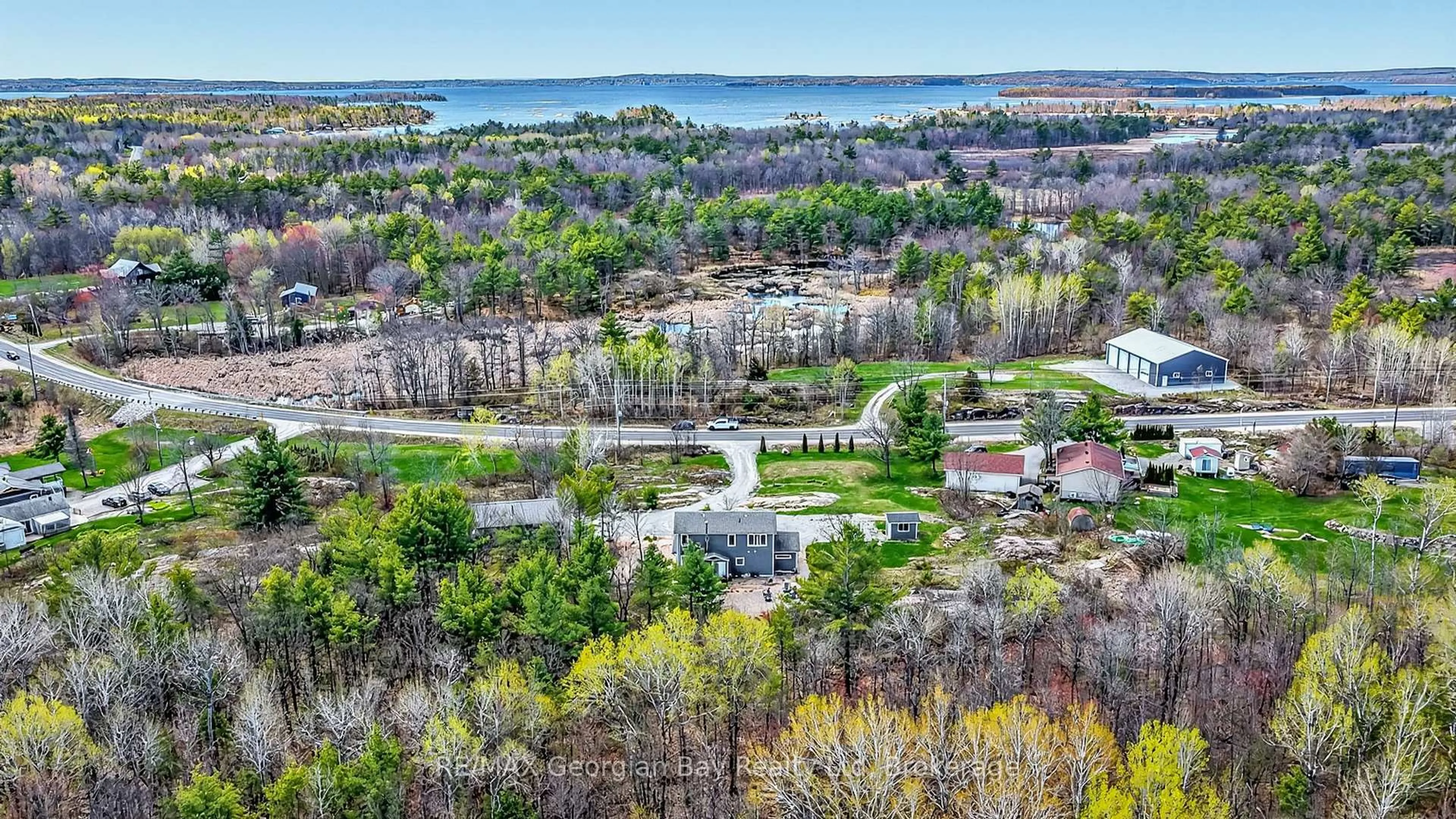 A pic from outside/outdoor area/front of a property/back of a property/a pic from drone, water/lake/river/ocean view for 1432 HONEY HARBOUR Rd, Georgian Bay Ontario L0K 1S0