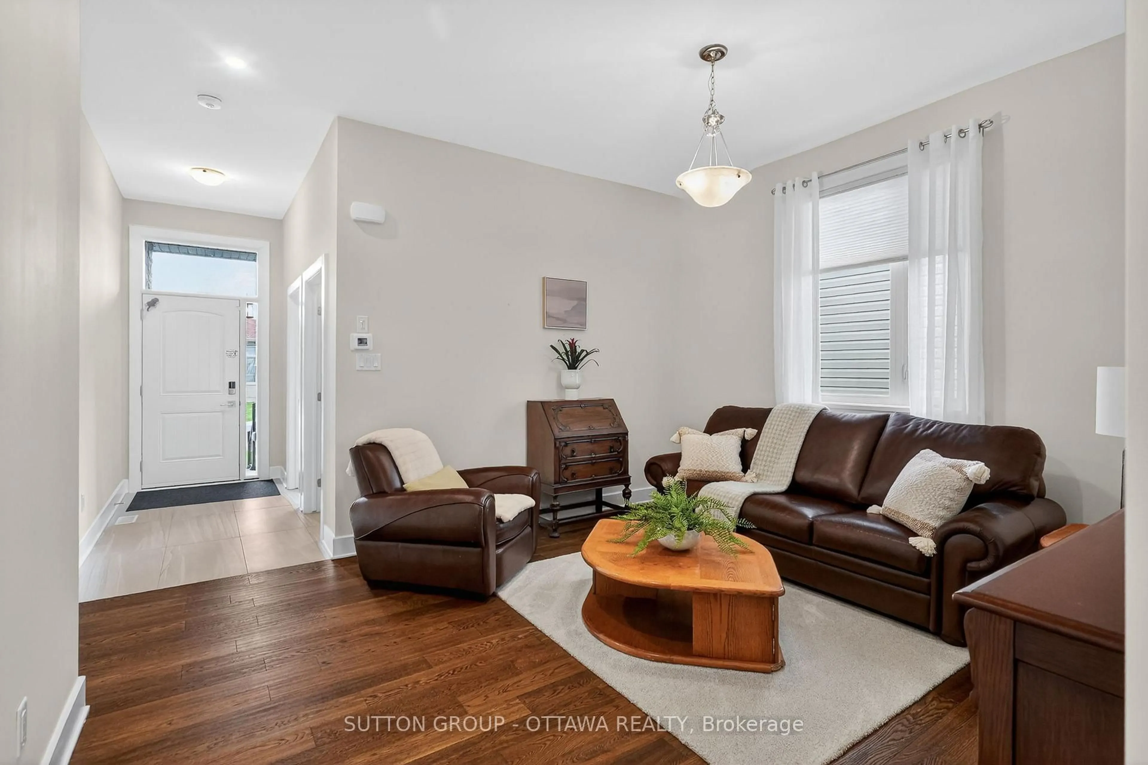 Living room with furniture, wood/laminate floor for 105 Dunlop Rd, Carleton Place Ontario K7C 0R8